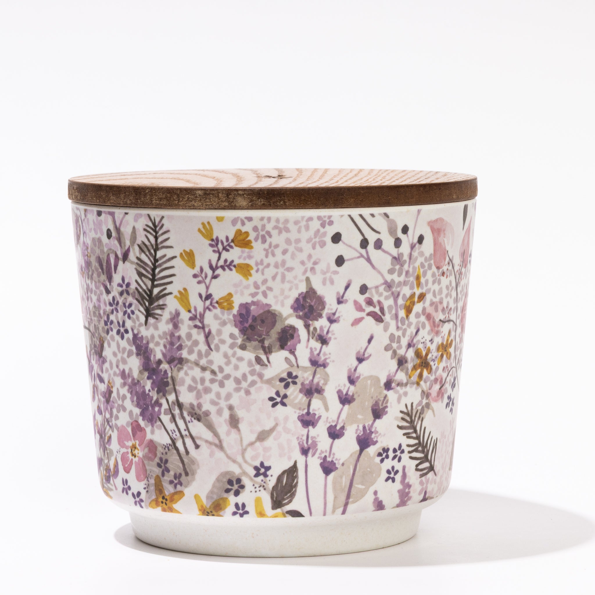 The Greenleaf Gifts Lavender Patterned 3 Wick Candle features a ceramic container with a wooden lid, decorated with colorful flowers and green leaves on white—perfect as a decorative lavender candle.