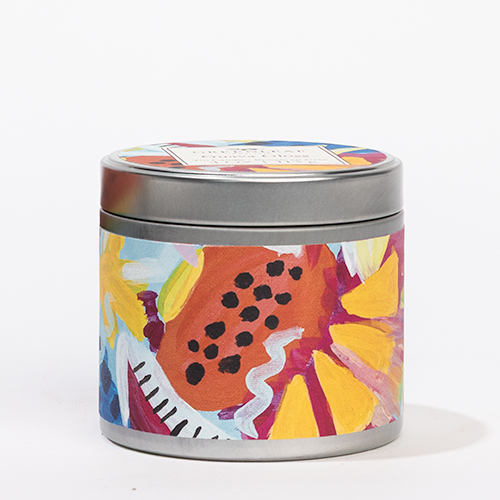 The Greenleaf Gifts Guava Gloss Tin Candle features a vibrant floral design with yellow, red, orange, and blue flowers on its round metal tin and matching lid. Enjoy its lively tropical scent; includes a rectangular label on top.