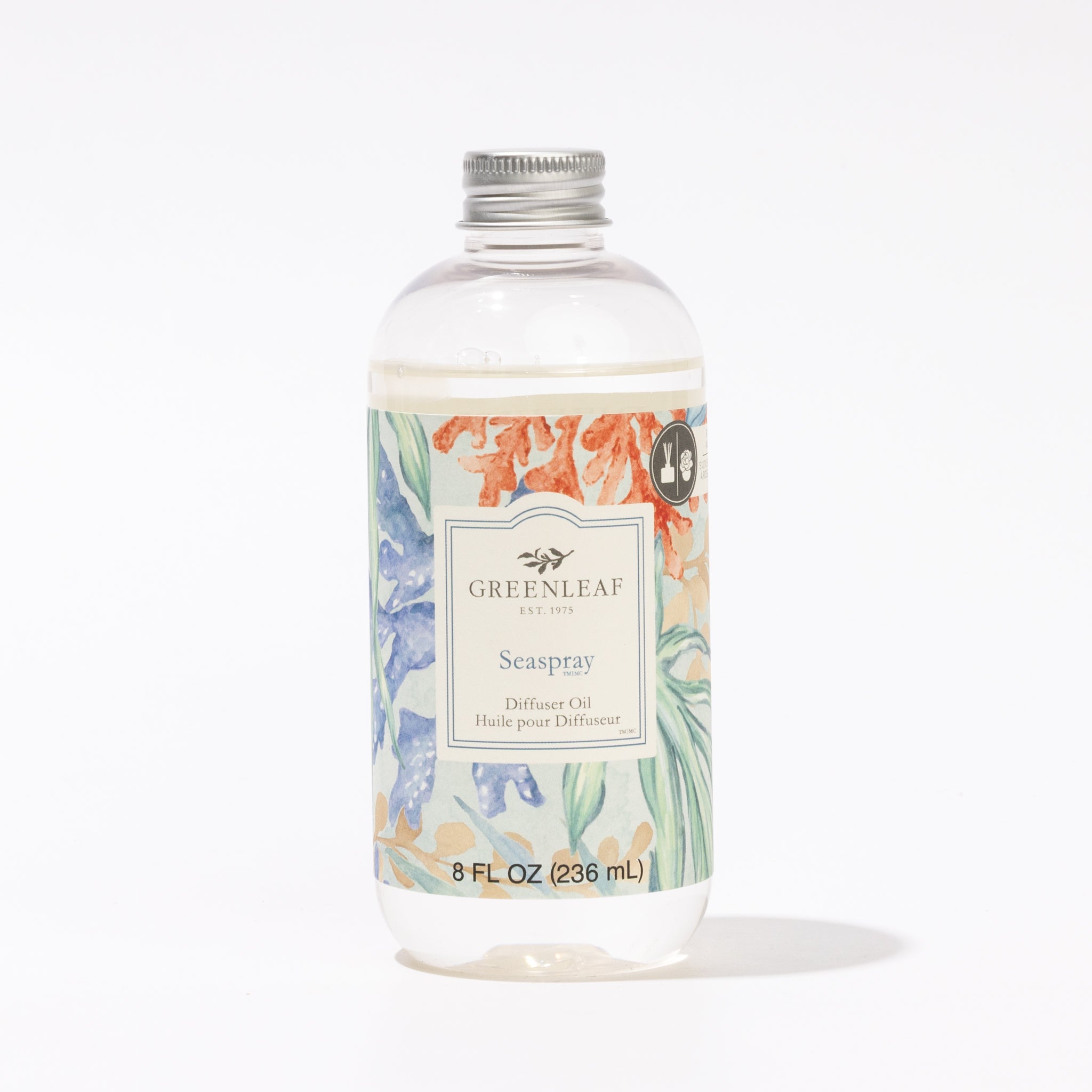 A clear plastic bottle of Greenleaf Gifts Seaspray Diffuser Oil features a silver cap and a label with pastel leaves. The white label displays the product name and 8 fl oz (236 ml) size in refreshing Seaspray fragrance.