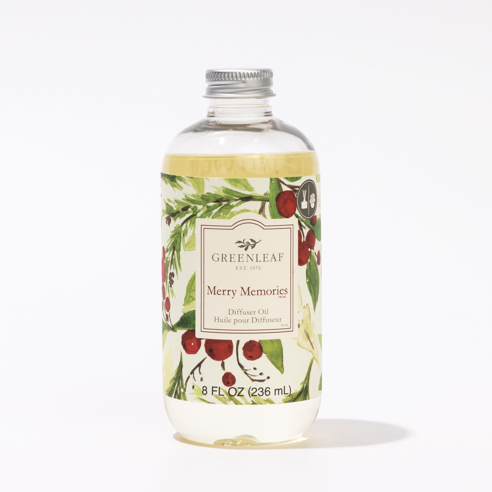 Greenleaf Gifts Merry Memories Diffuser Oil comes in an 8 fl oz (236 mL) clear bottle with a silver cap and festive botanical label. Ideal for your reed diffuser, it features red berries and green foliage for a cheerful touch.