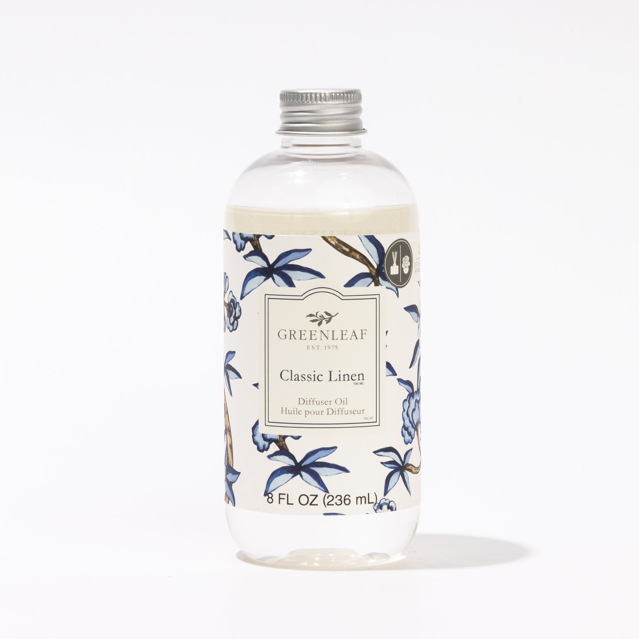 A clear, cylindrical 8 fl oz (236 mL) bottle of Greenleaf Gifts Classic Linen Diffuser Oil, featuring a silver cap and a blue and white floral label.