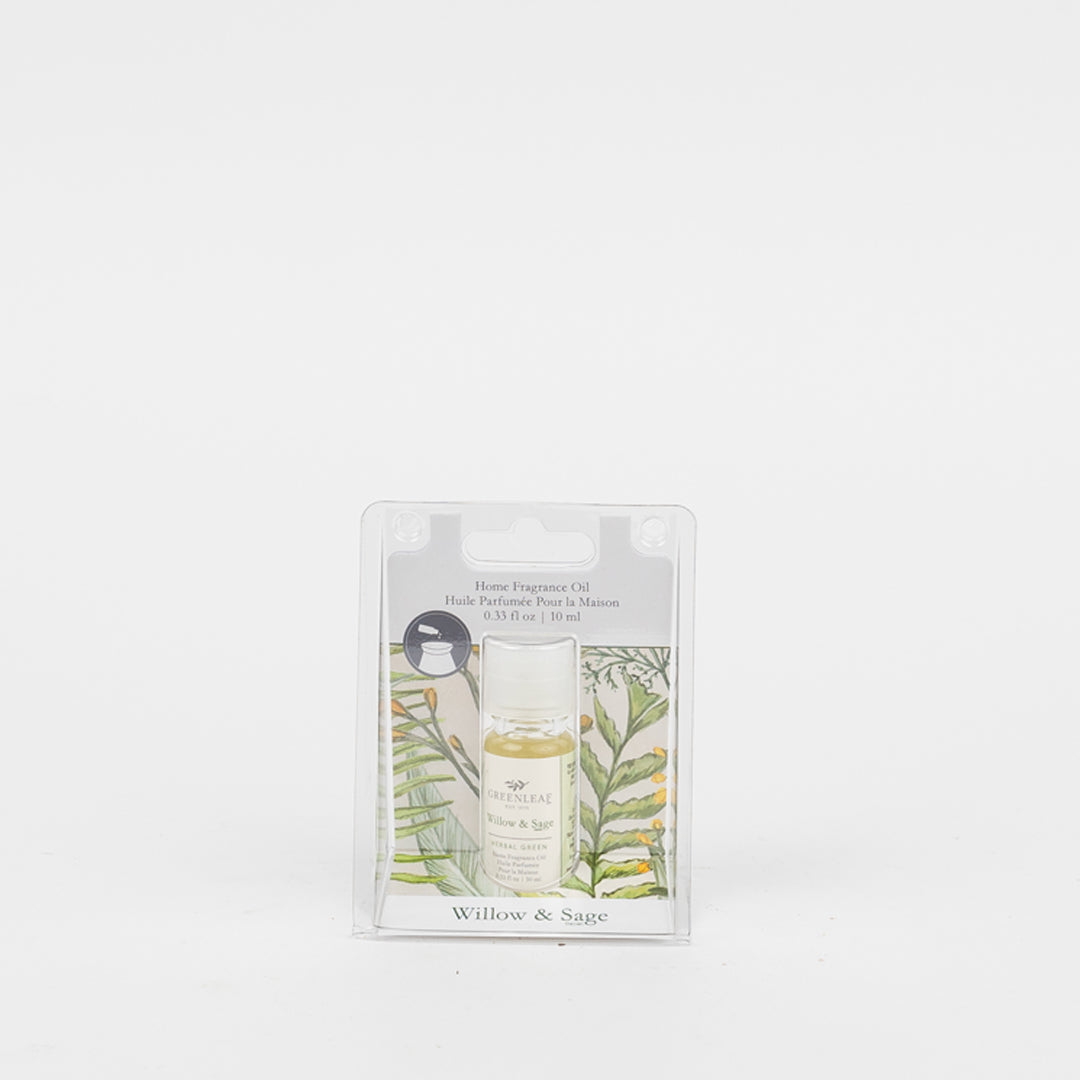 The Greenleaf Gifts Willow & Sage Home Fragrance Oil comes in a small clear bottle with a botanical leaf design, providing a flameless fragrance experience and showcased against a plain white background.