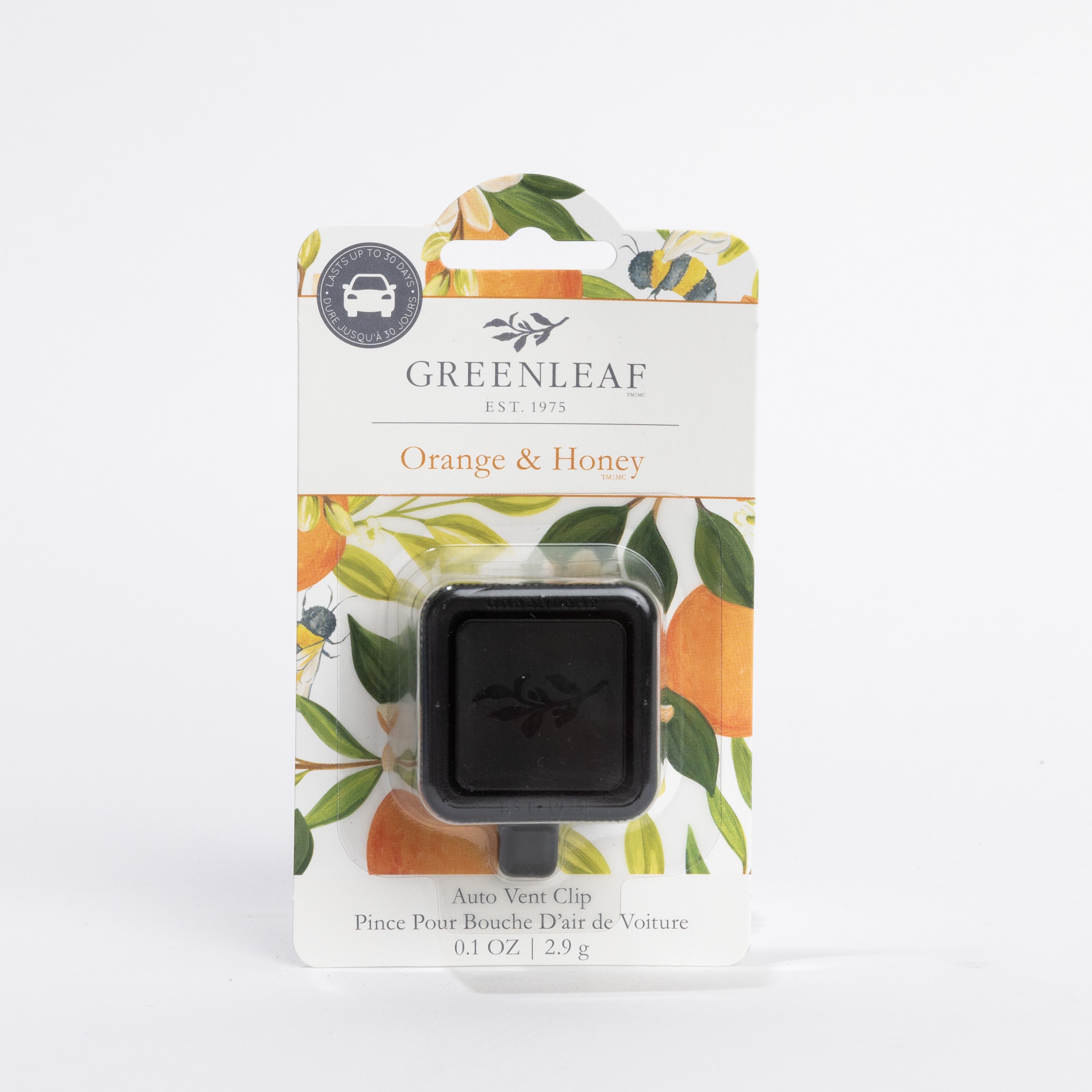 The Greenleaf Gifts Orange & Honey Auto Vent Clip features a black vent clip and comes in white floral packaging with green leaves and orange illustrations.