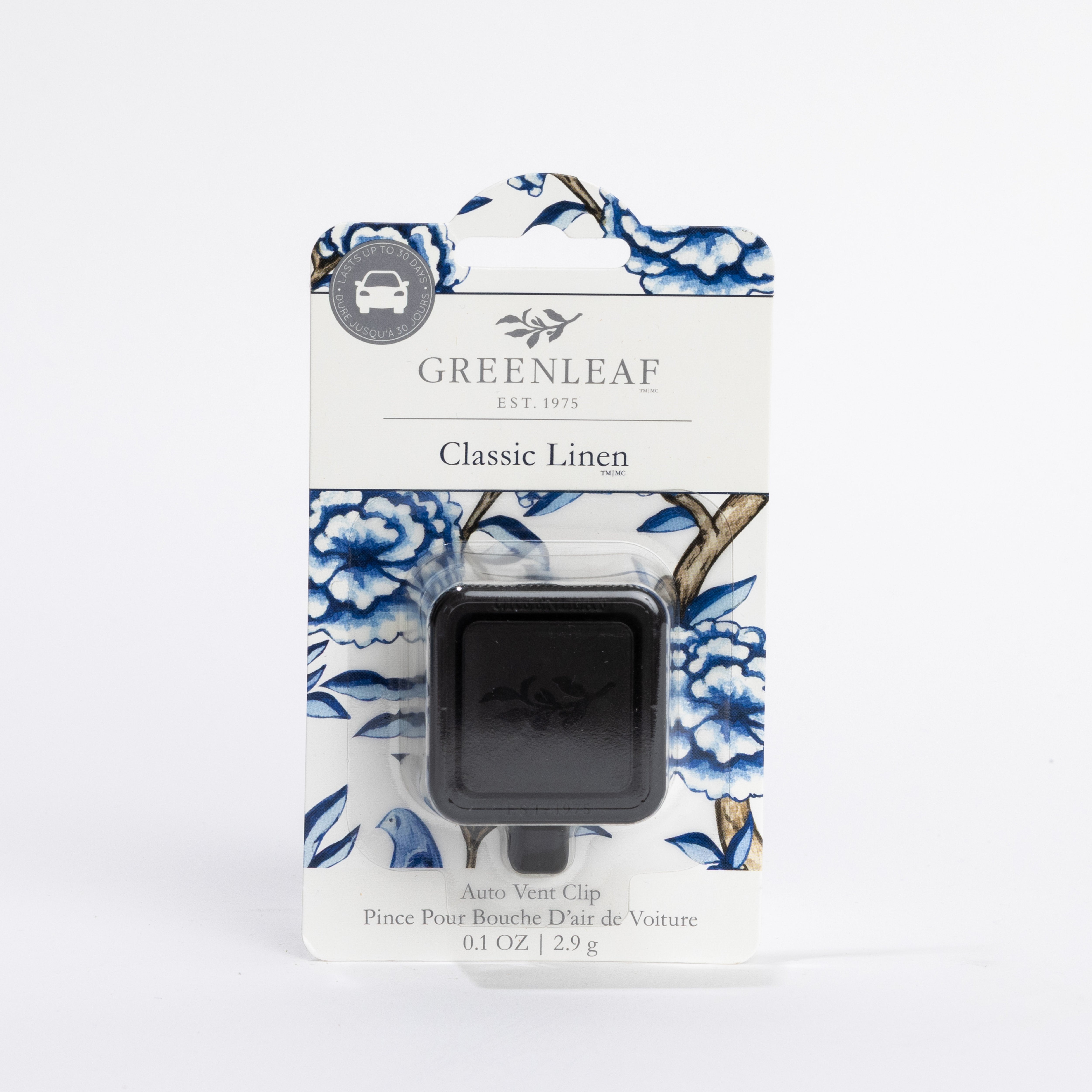 A Greenleaf Gifts Classic Linen Auto Vent Clip car air freshener in black packaging, shown on a white background with blue floral accents. It contains 0.1 oz (2.9g) of fragrance, ideal for refreshing your car vents.
