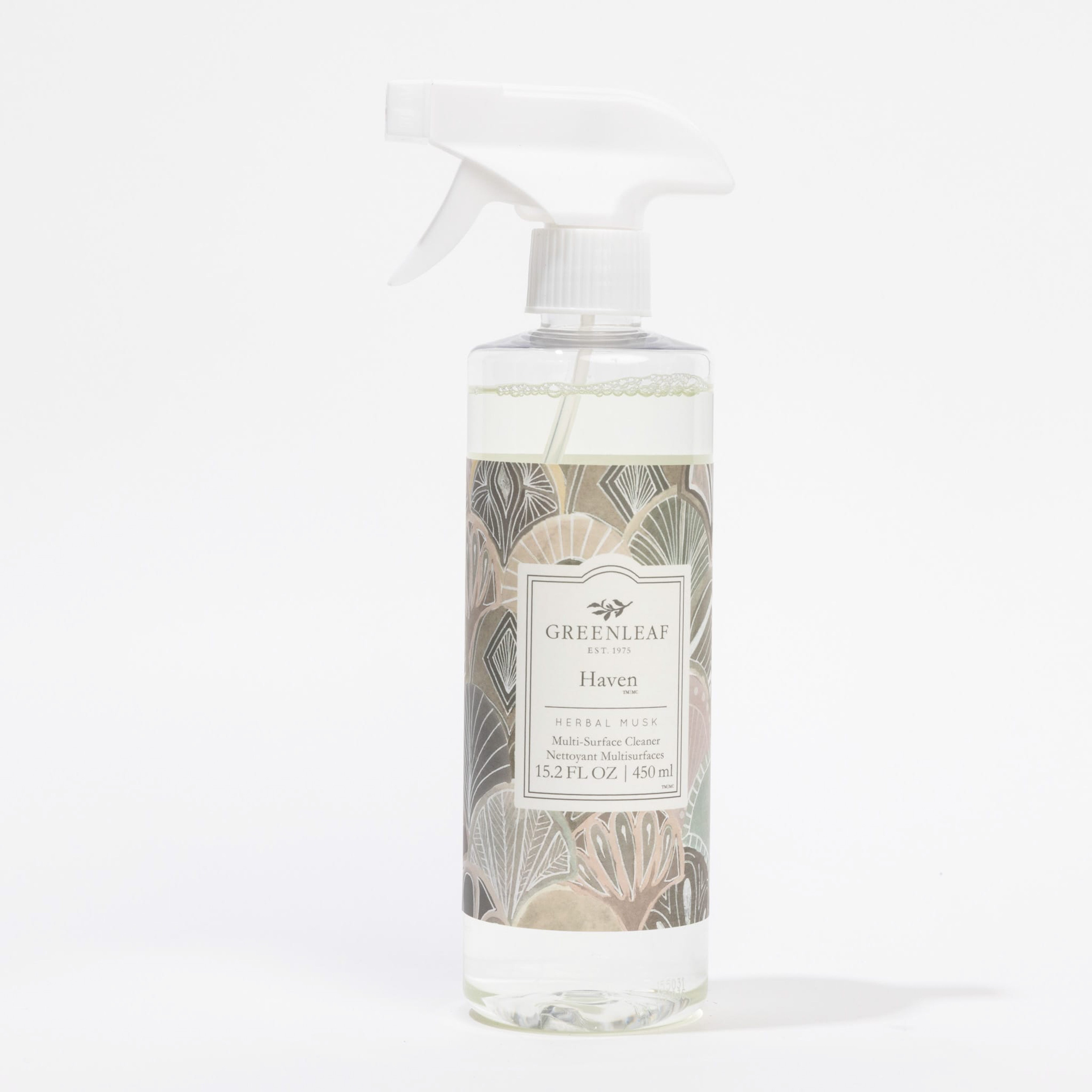 A 15.2 fl oz (450 ml) clear spray bottle of Greenleaf Gifts Haven Multi-Surface Cleaner features a white trigger nozzle, an art deco label in beige, pink, and green tones, effectively cleans non-porous surfaces, and leaves a fresh scent.