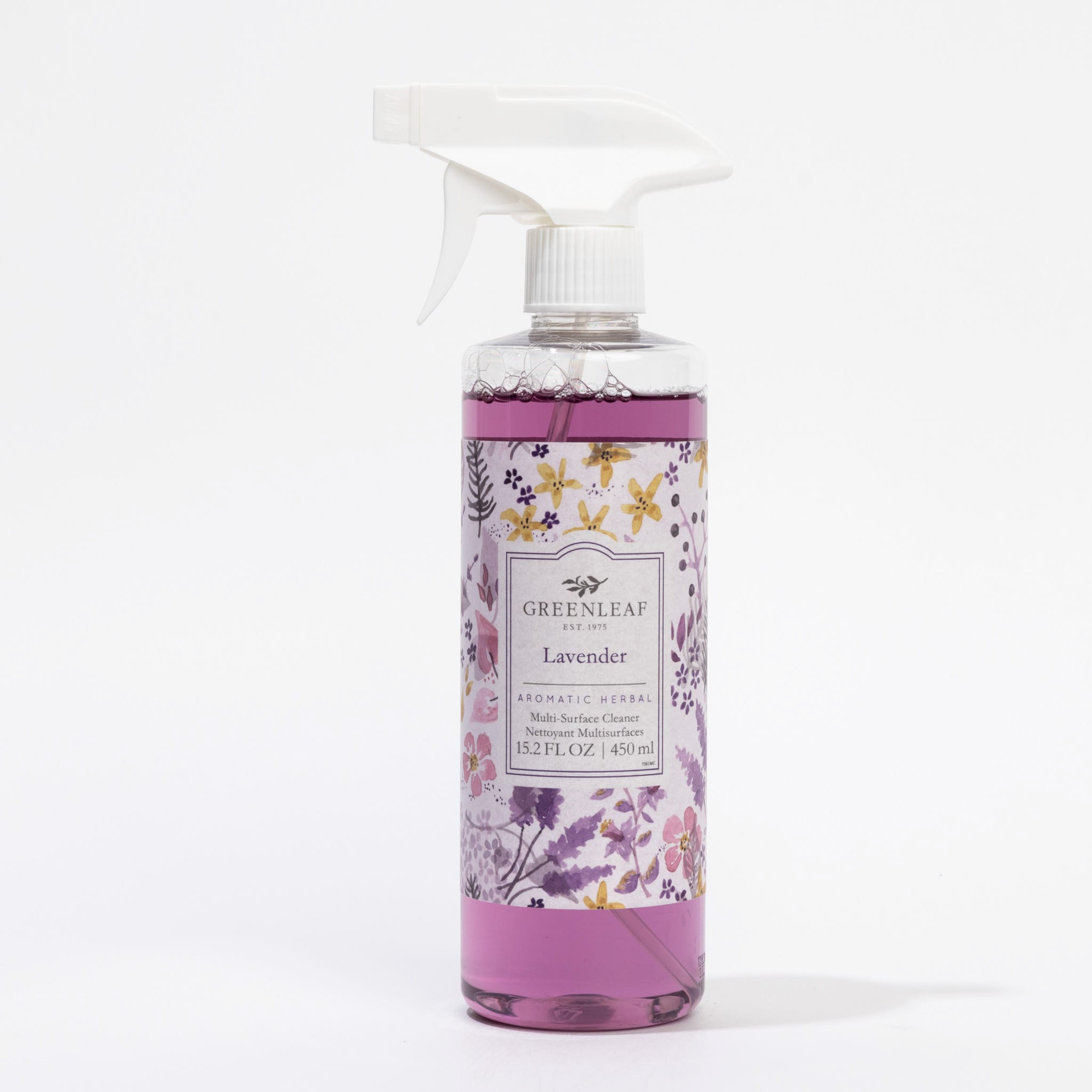 A spray bottle of Greenleaf Gifts Lavender Multi-Surface Cleaner with purple liquid and a floral label offers your home a fresh lavender fragrance.