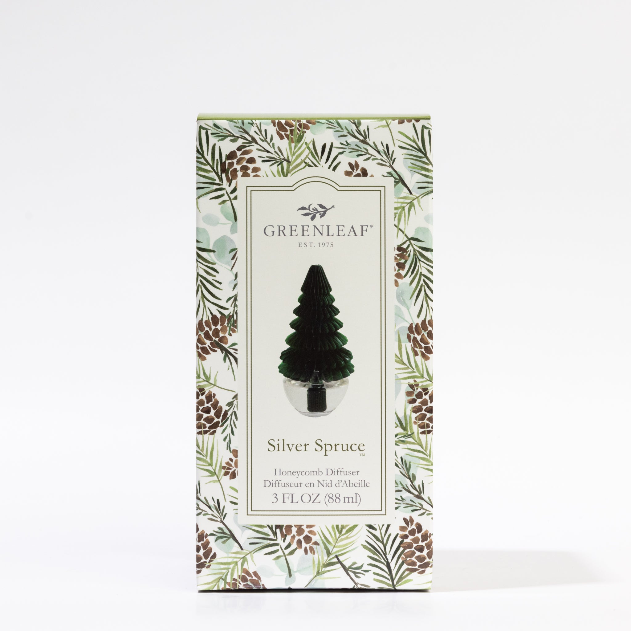 A box of Greenleaf Gifts Silver Spruce Tree Honeycomb Diffuser (3 fl oz) with a tree-shaped design and honeycomb detail, featuring pine branches and cones—ideal for holiday decor.