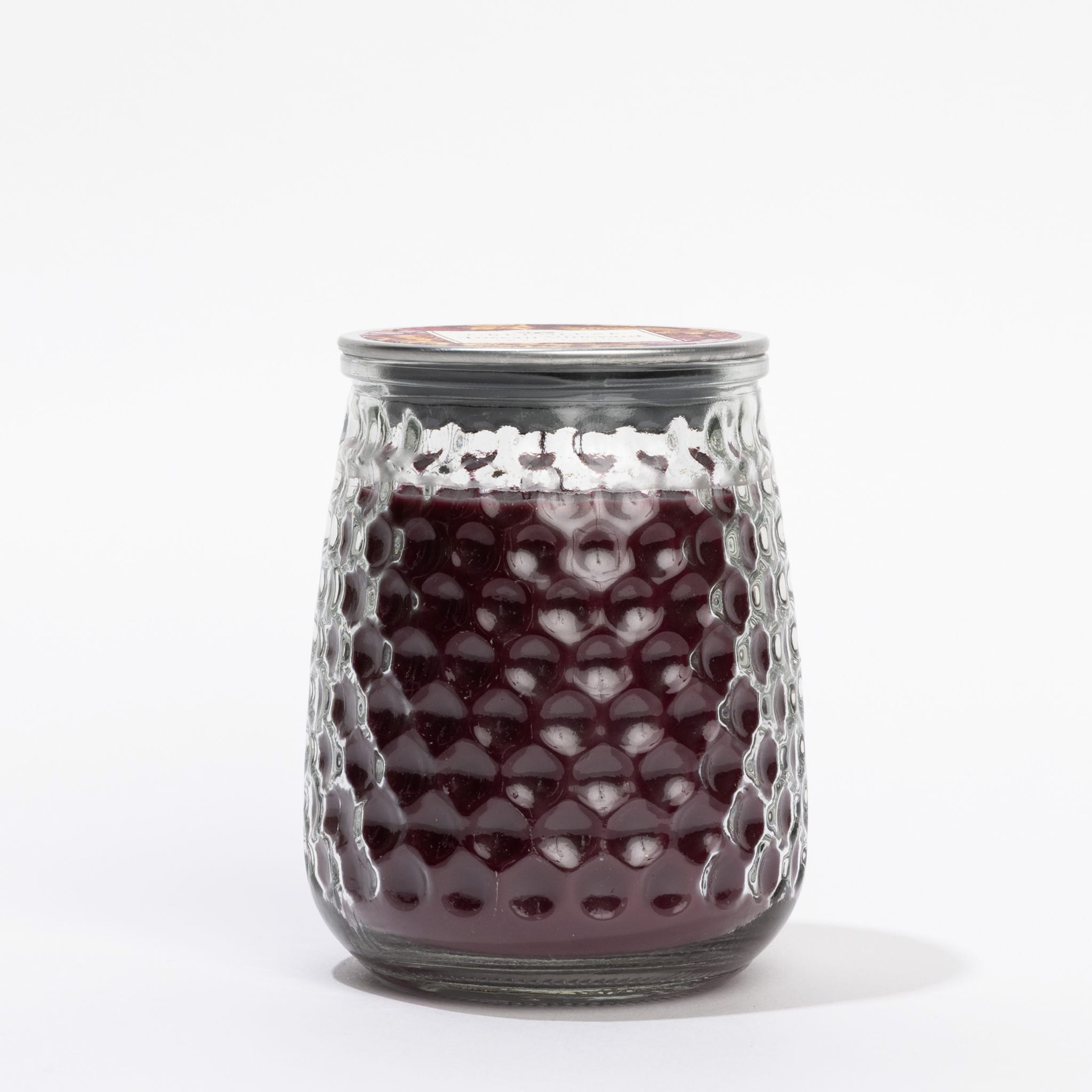 A clear, textured glass jar from Greenleaf Gifts holds the Tuscan Vineyard Signature Candle in a deep purple hue, sealed with a metal lid and displayed against a plain white background.
