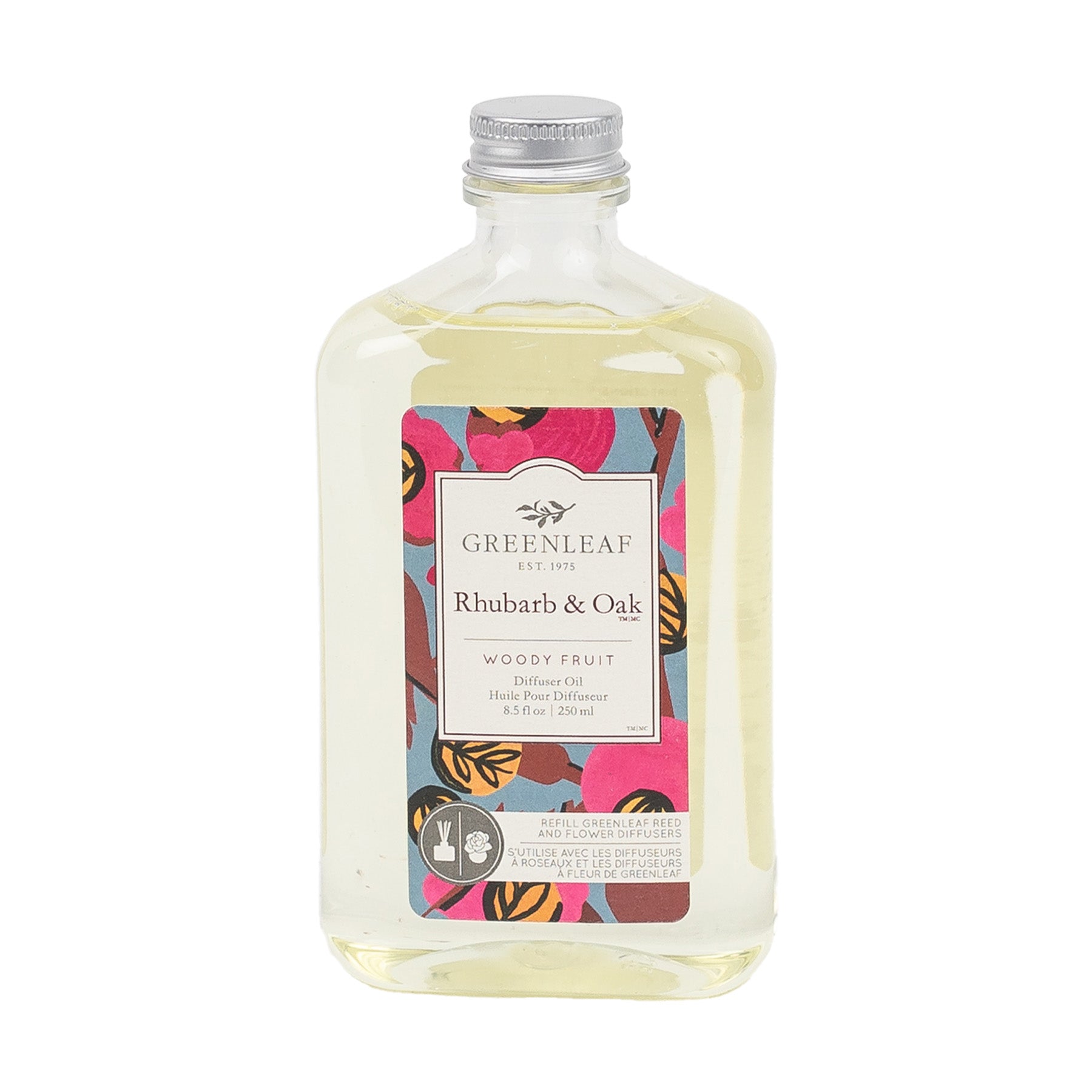 A clear bottle of Greenleaf Gifts Rhubarb & Oak Diffuser Oil Refill with a silver cap. The front label has a colorful floral design and product details, while the bottle contains pale yellow fragrance oil.