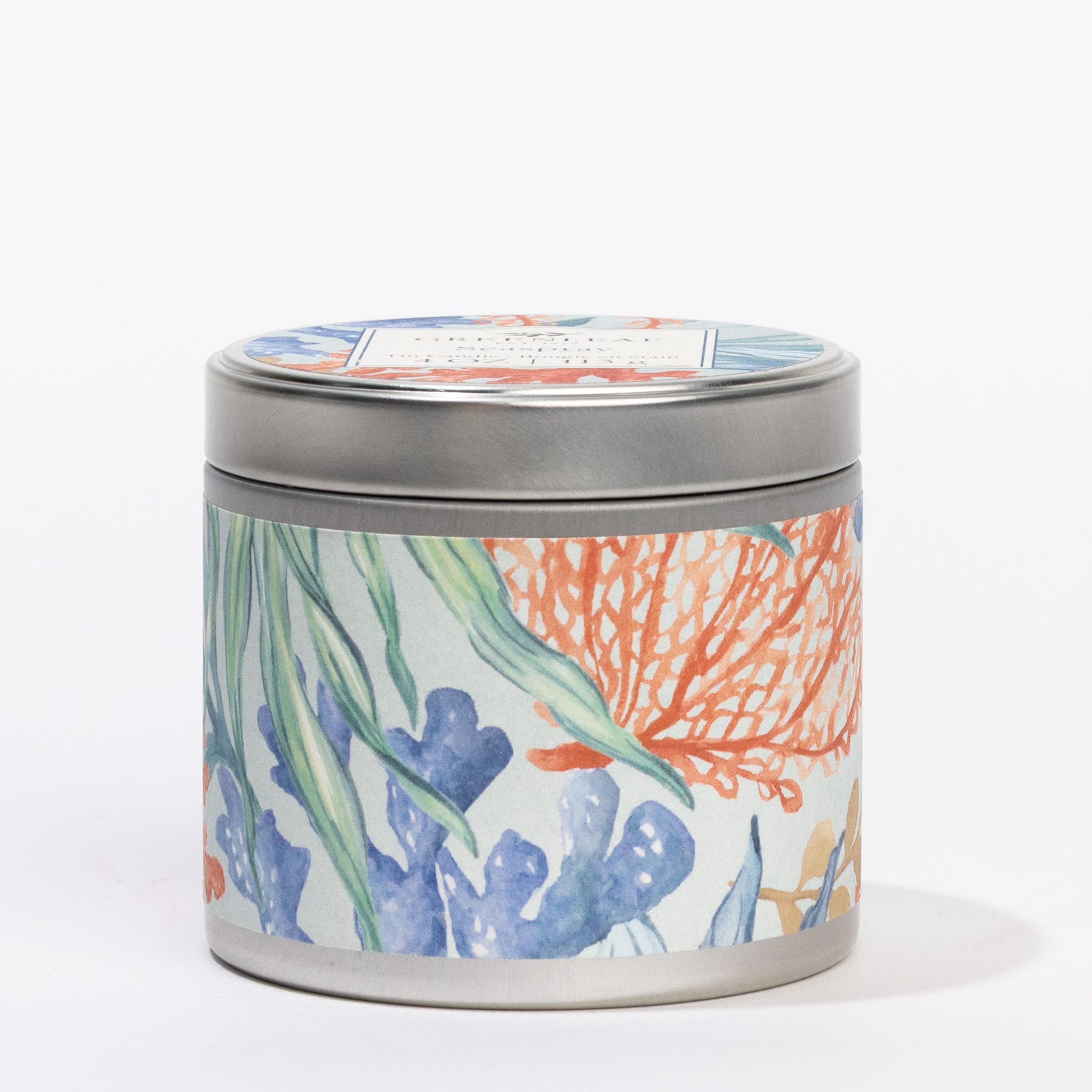 The Seaspray Tin Candle by Greenleaf Gifts features a round metal tin with a vibrant botanical design and matching lid. Enjoy its fresh seaspray fragrance anywhere with this portable, decorative candle.