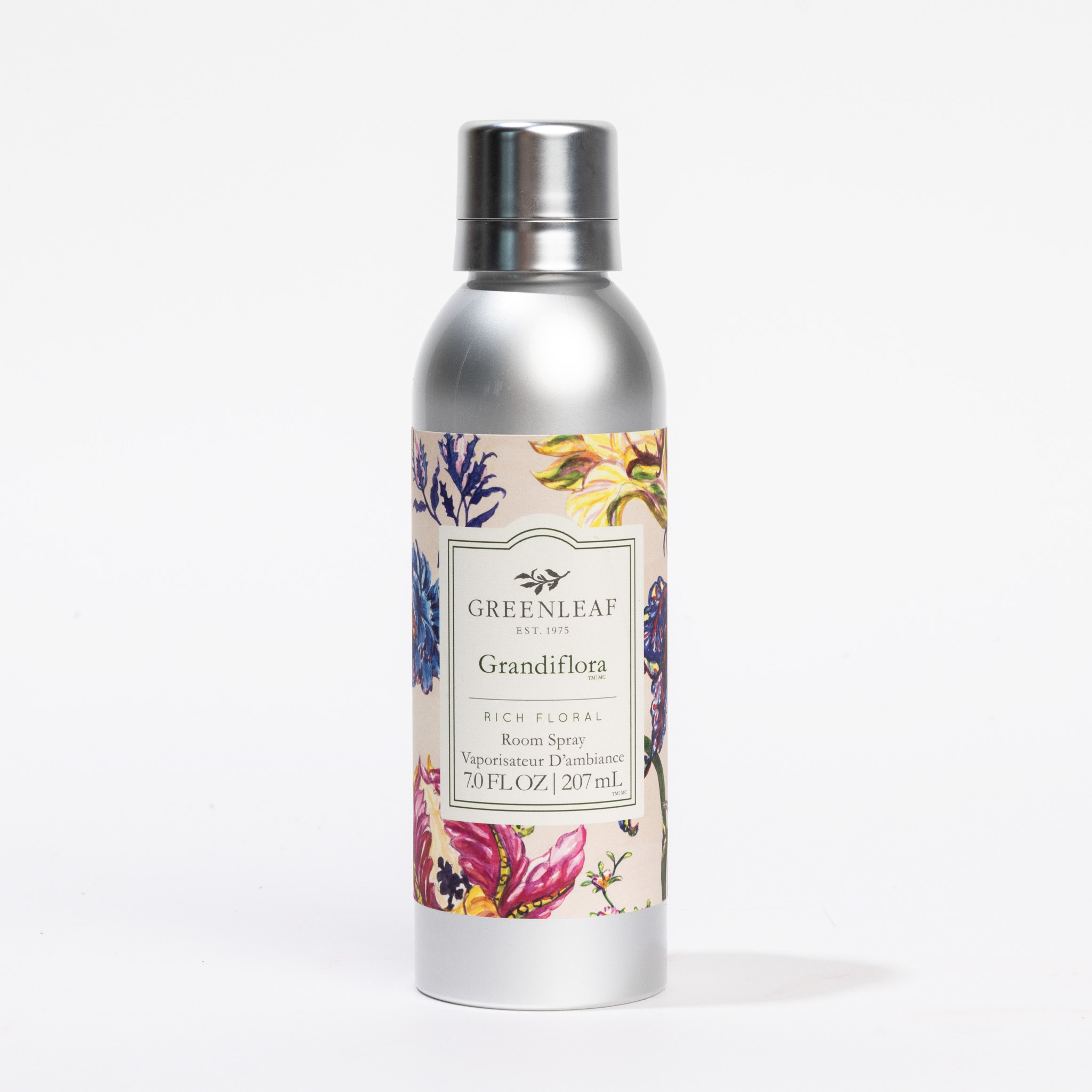 A silver can of Greenleaf Gifts Grandiflora Room Spray with a floral label featuring colorful flowers and foliage, set against a white background—a refreshing Greenleaf fragrance for your space.