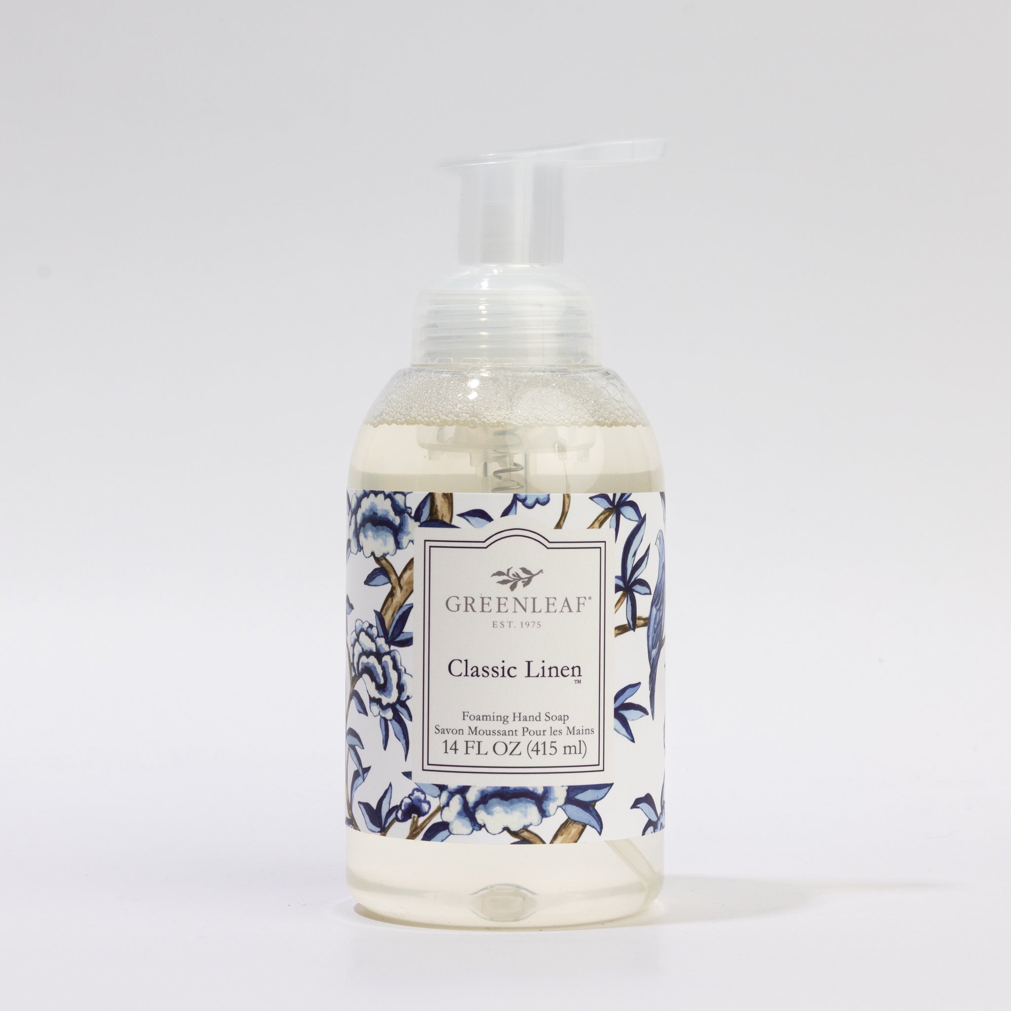 A clear pump bottle of Greenleaf Gifts Classic Linen Foaming Hand Soap (14 fl oz, GLG321498S) with a floral blue and white label is shown against a plain white background.
