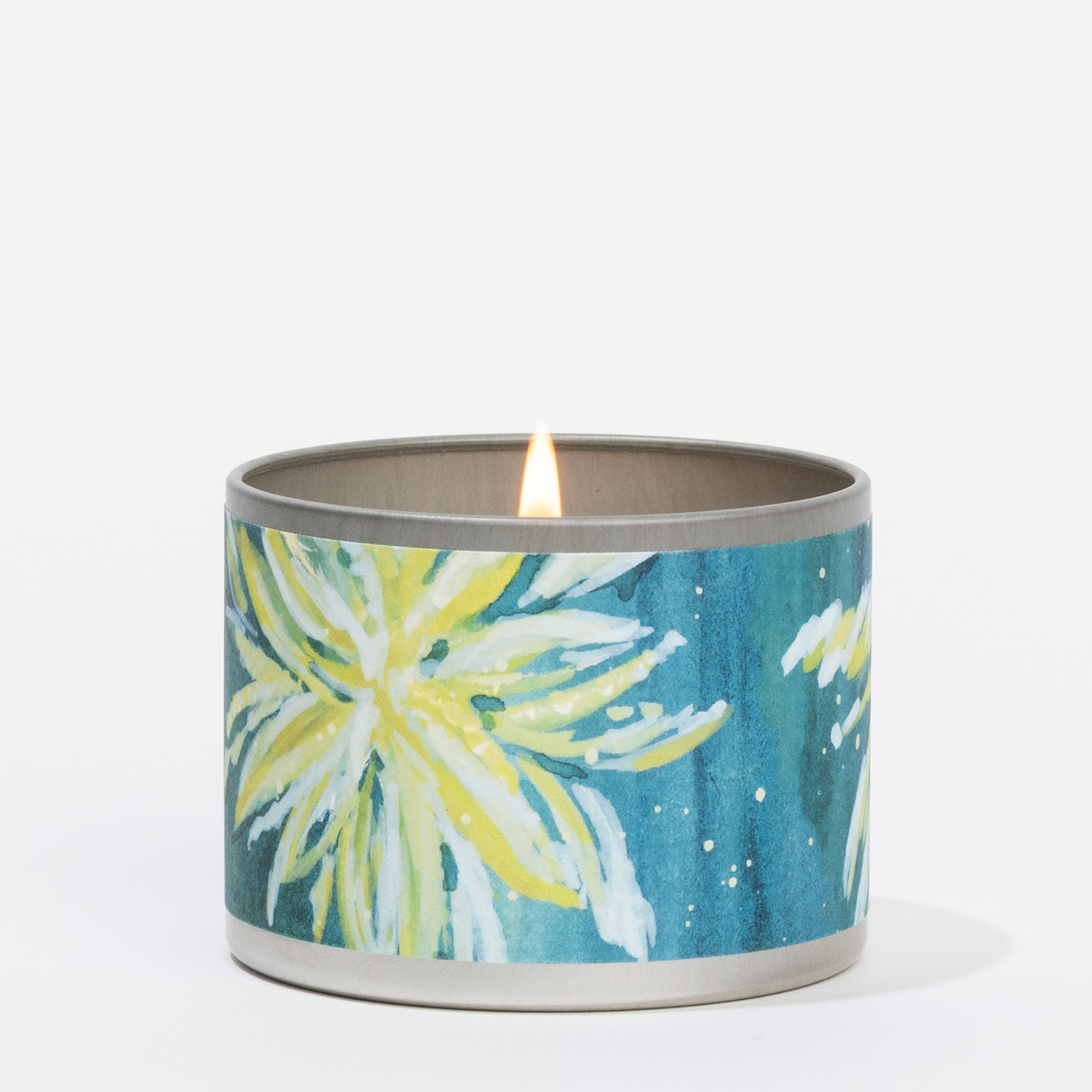 The Greenleaf Gifts Spa Springs Tin Candle, in a round metallic container with blue and green floral patterns and large yellow and white flowers, evokes tranquil spa serenity against a plain white background.