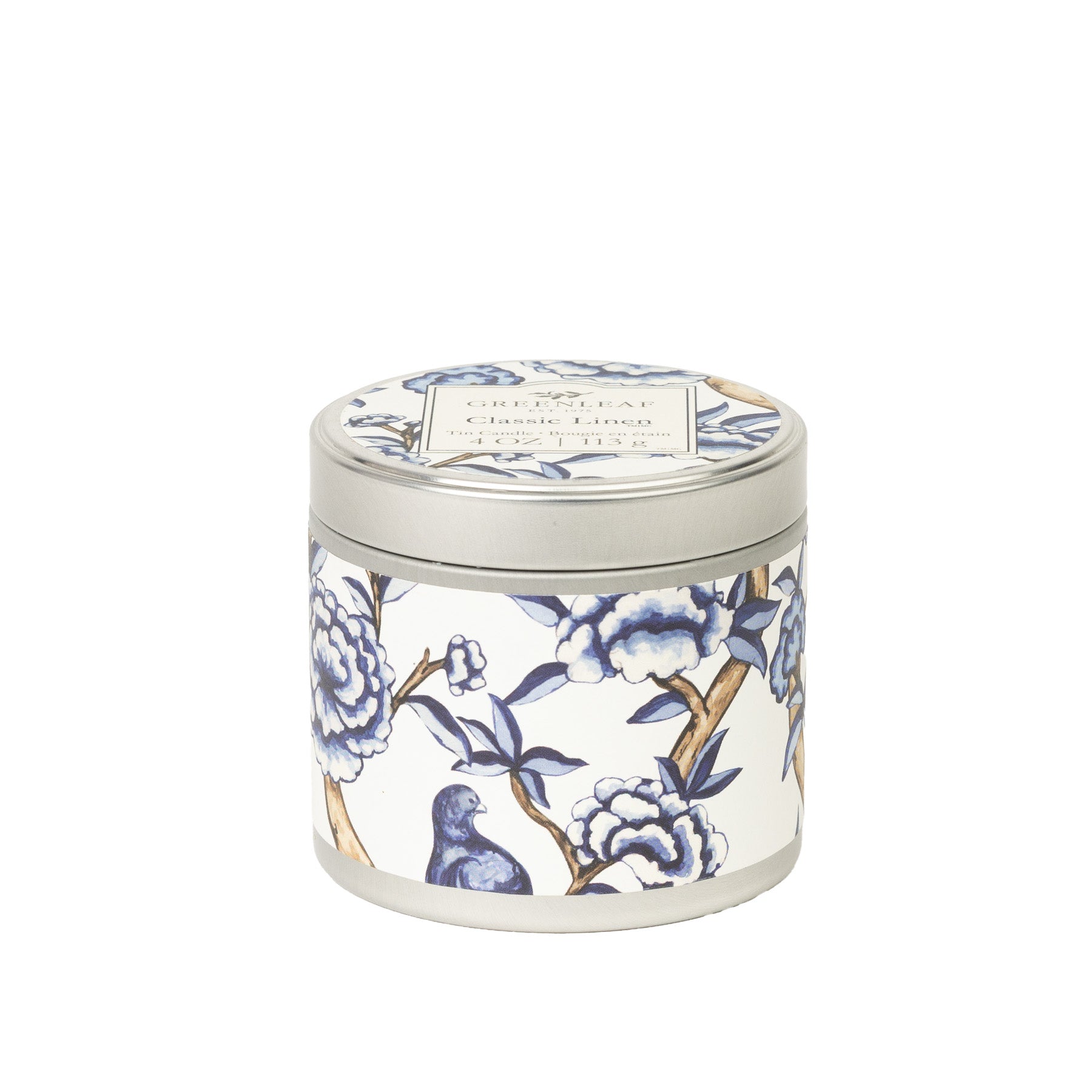 The Classic Linen Tin Candle by Greenleaf Gifts features a portable tin with a lid, adorned in blue and white floral and bird designs—a stylish choice for travel or home décor.