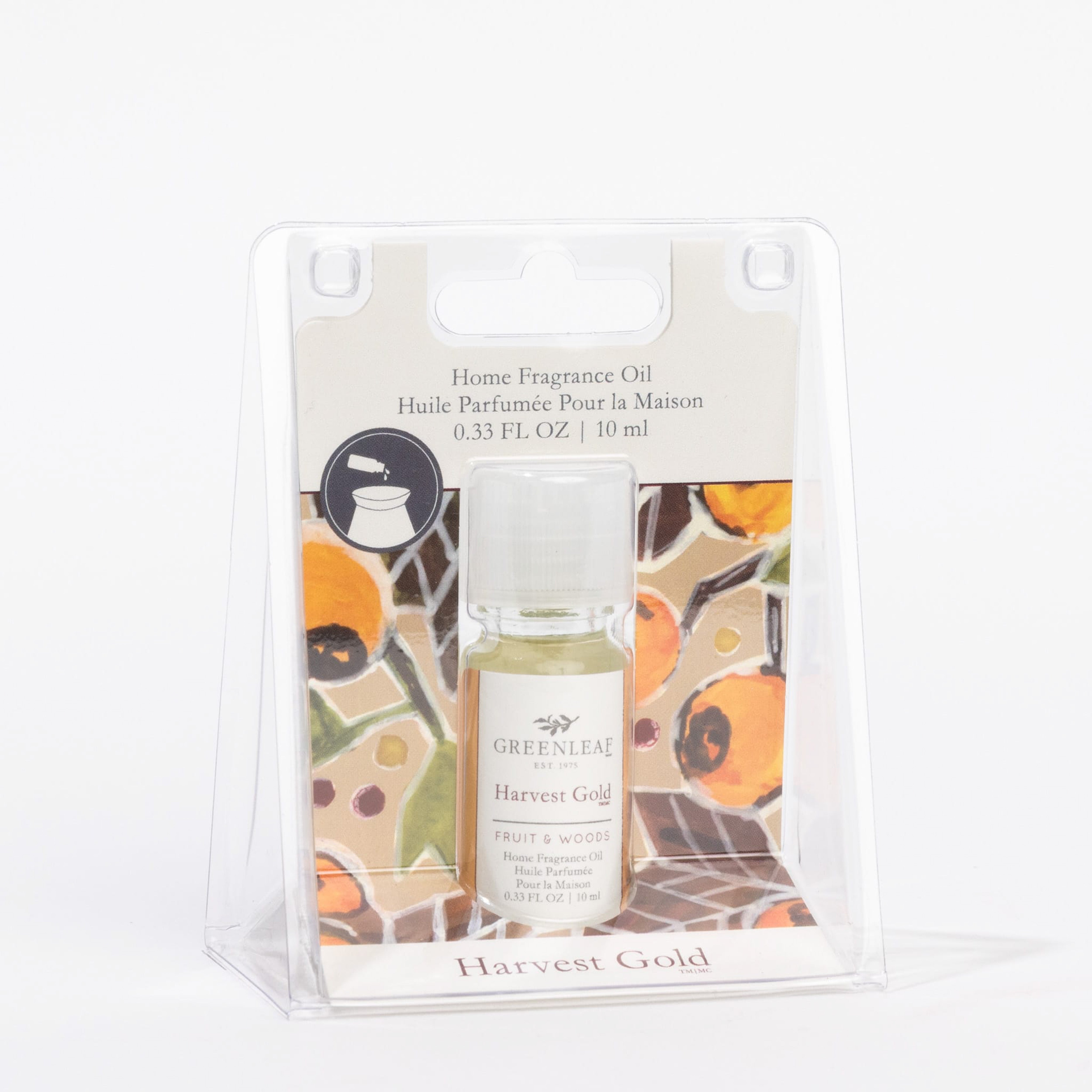 Greenleaf Gifts Harvest Gold Home Fragrance Oil comes in a 0.33 FL OZ (10 ml) bottle, packaged in a clear plastic box with a floral background. This flameless oil blends Fruit & Woods notes for a refreshing scent experience.