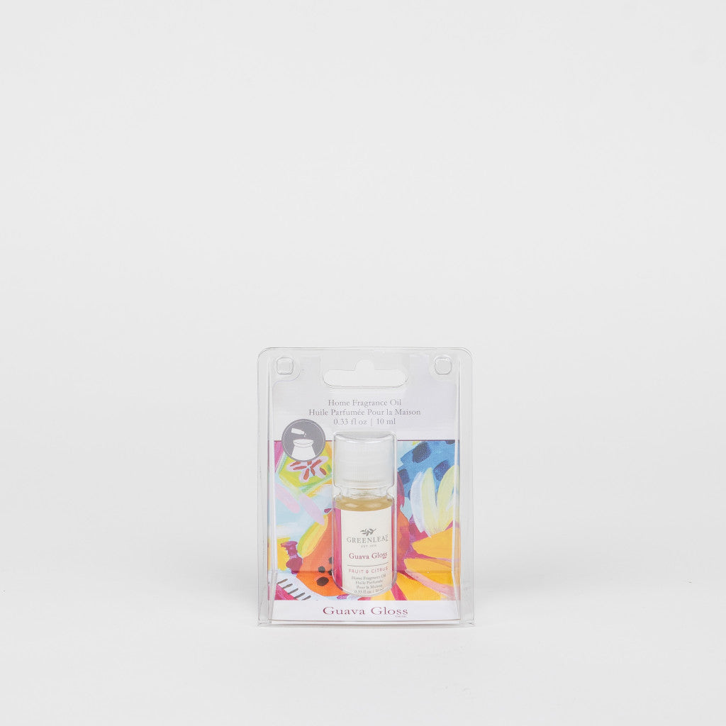 A small bottle of Greenleaf Gifts Guava Gloss Home Fragrance Oil, ideal for flameless fragrance, comes in a clear plastic case with colorful artwork on the insert, displayed against a plain white background.