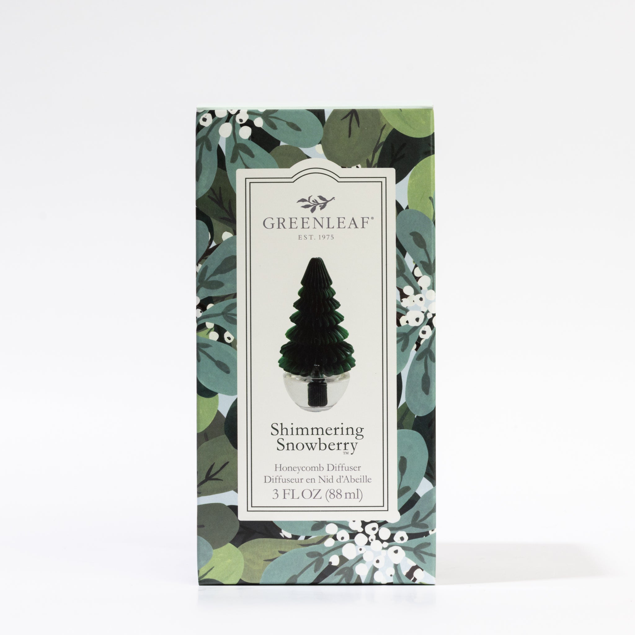 The Greenleaf Gifts Shimmering Snowberry Tree Honeycomb Diffuser features a festive green tree-shaped design, leafy holiday packaging with white berries, and comes with 3 fl. oz. (88 ml)—perfect for seasonal decor.