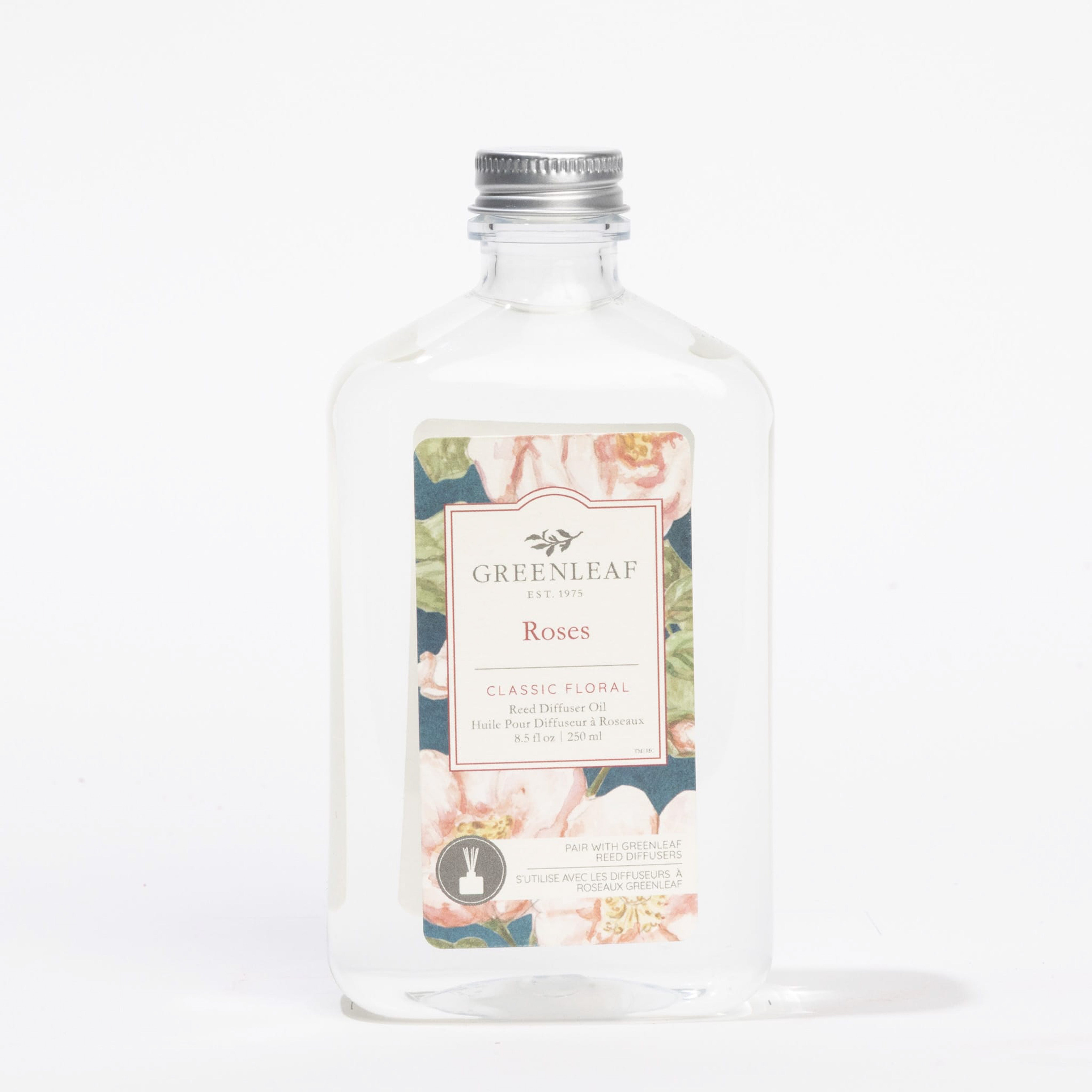 A clear bottle of Fast Bundle Roses Flower Diffuser & Fragrance Refill Oil with a silver cap features floral artwork and a Classic Floral scent description. Ideal for diffuser refills, the product is shown against a white background.