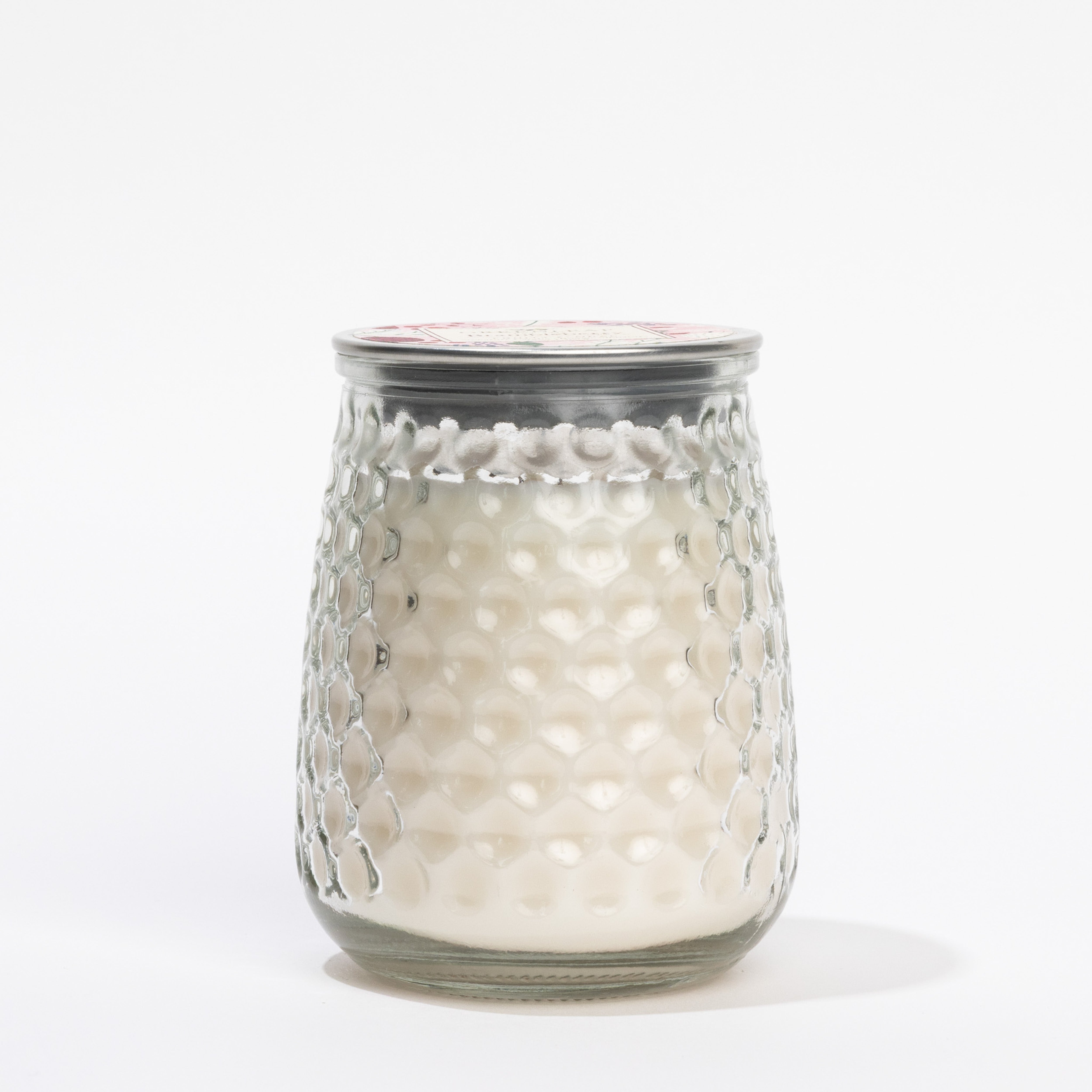 The Brambleberry Signature Candle by Greenleaf Gifts features white wax in a textured glass hobnail jar with a metal lid and an inviting Brambleberry scent, shown against a plain white background.