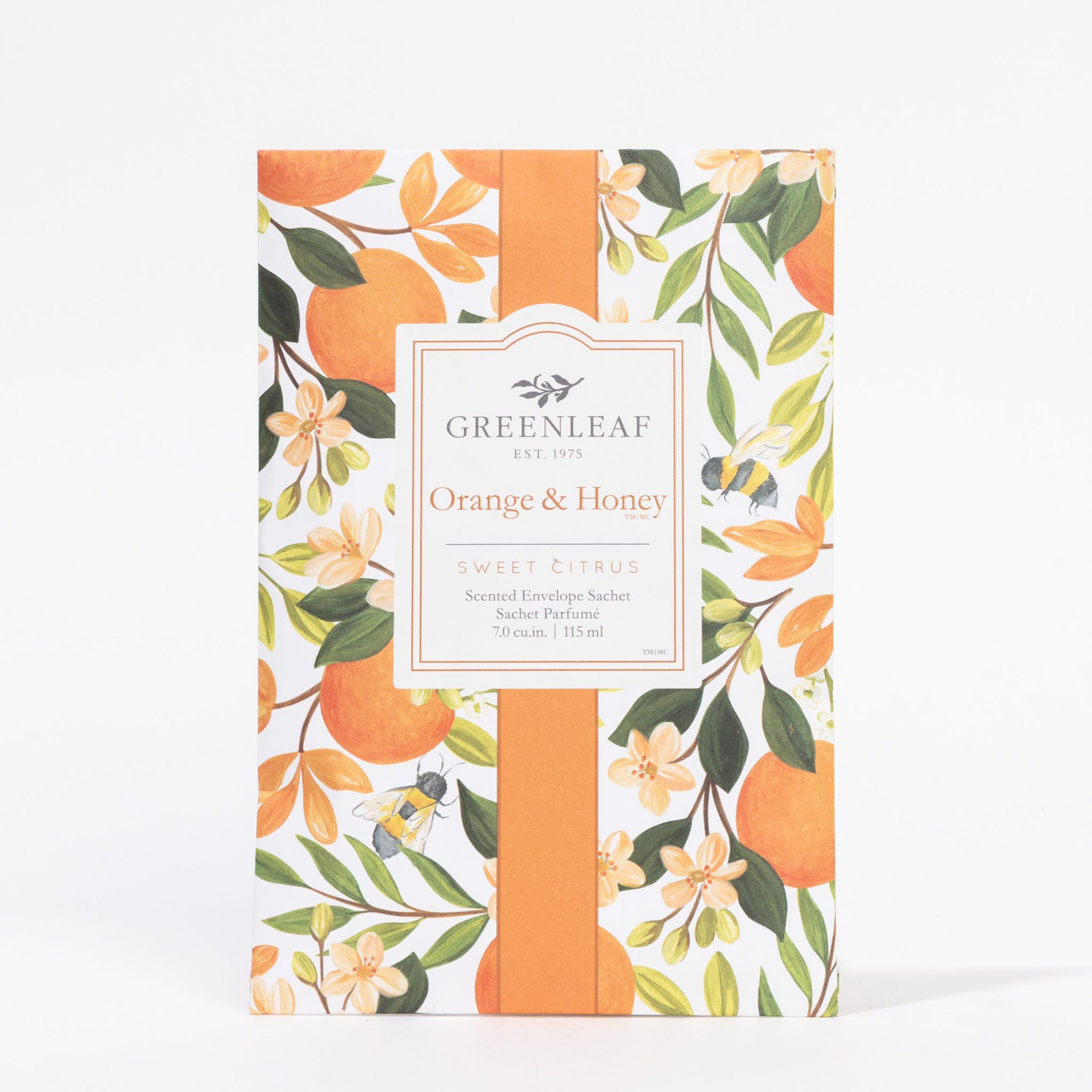 The Greenleaf Gifts Orange & Honey Sachet is a long-lasting air freshener with a sweet citrus scent, featuring orange, blossom, and green leaf illustrations on a white background.