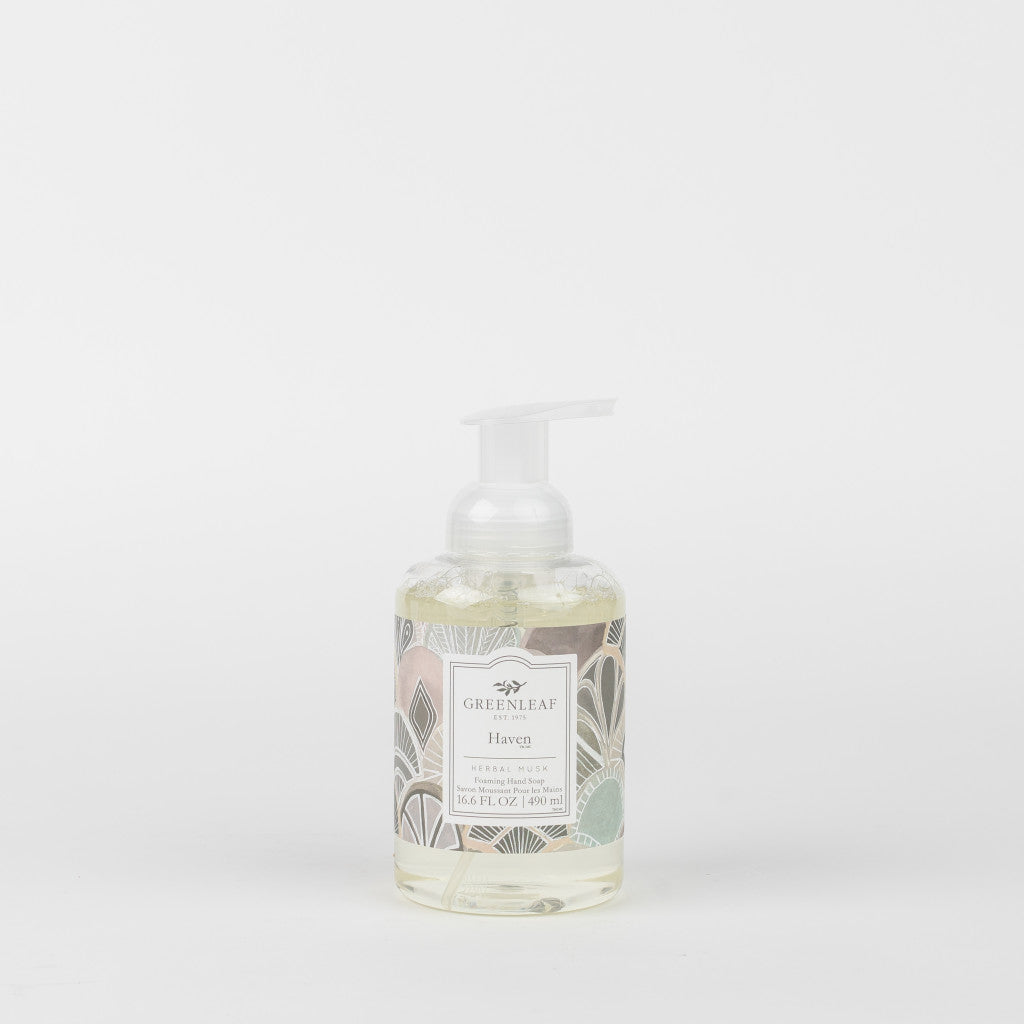 A clear pump bottle of Greenleaf Gifts Haven Foaming Hand Soap with coconut oil and a pastel leaf-patterned label, shown against a plain white background.