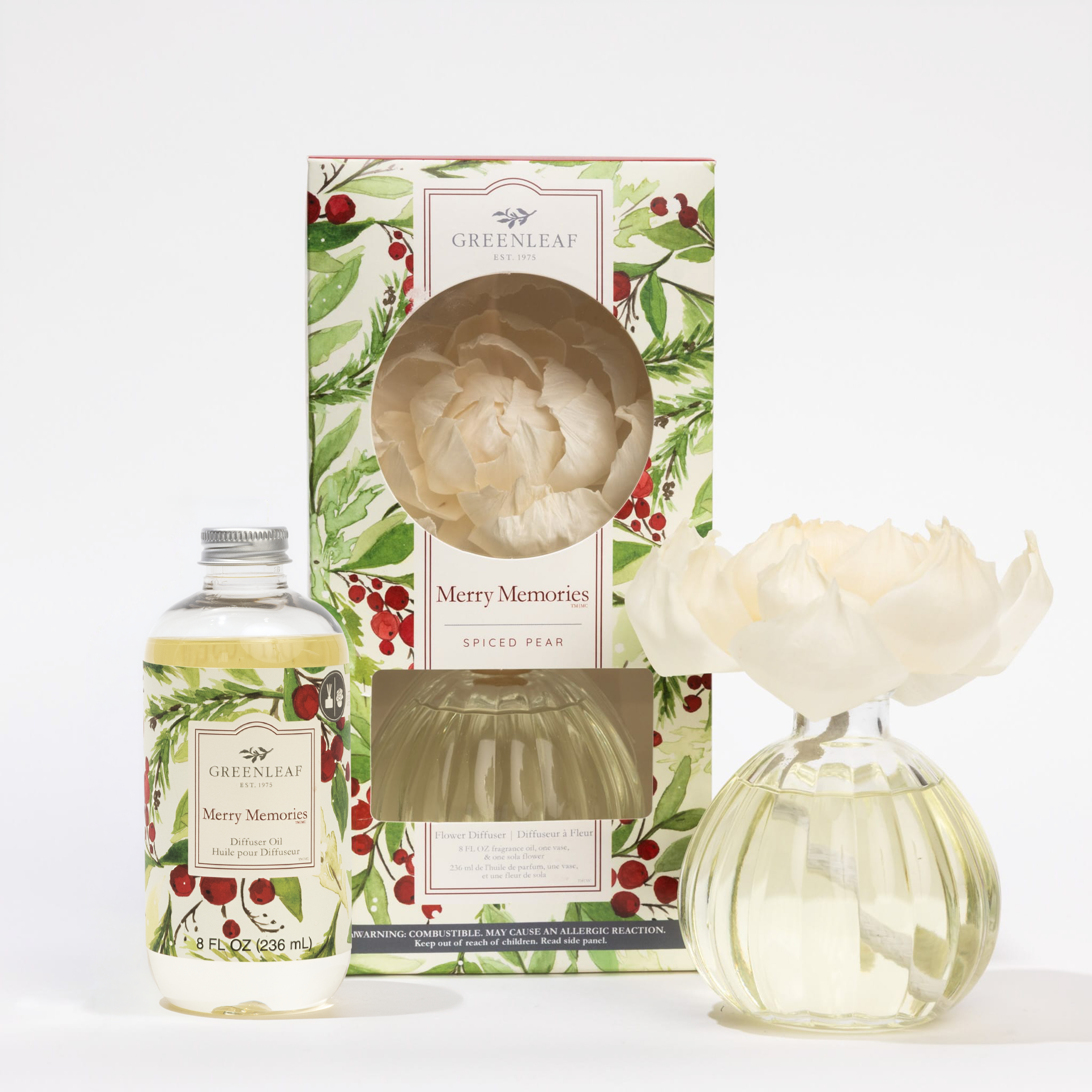 The Fast Bundle Merry Memories Flower Diffuser & Fragrance Refill Oil set includes a spiced pear scent, floral reed, holly-designed decorative box, and a clear oil bottle beside the diffuser vase.