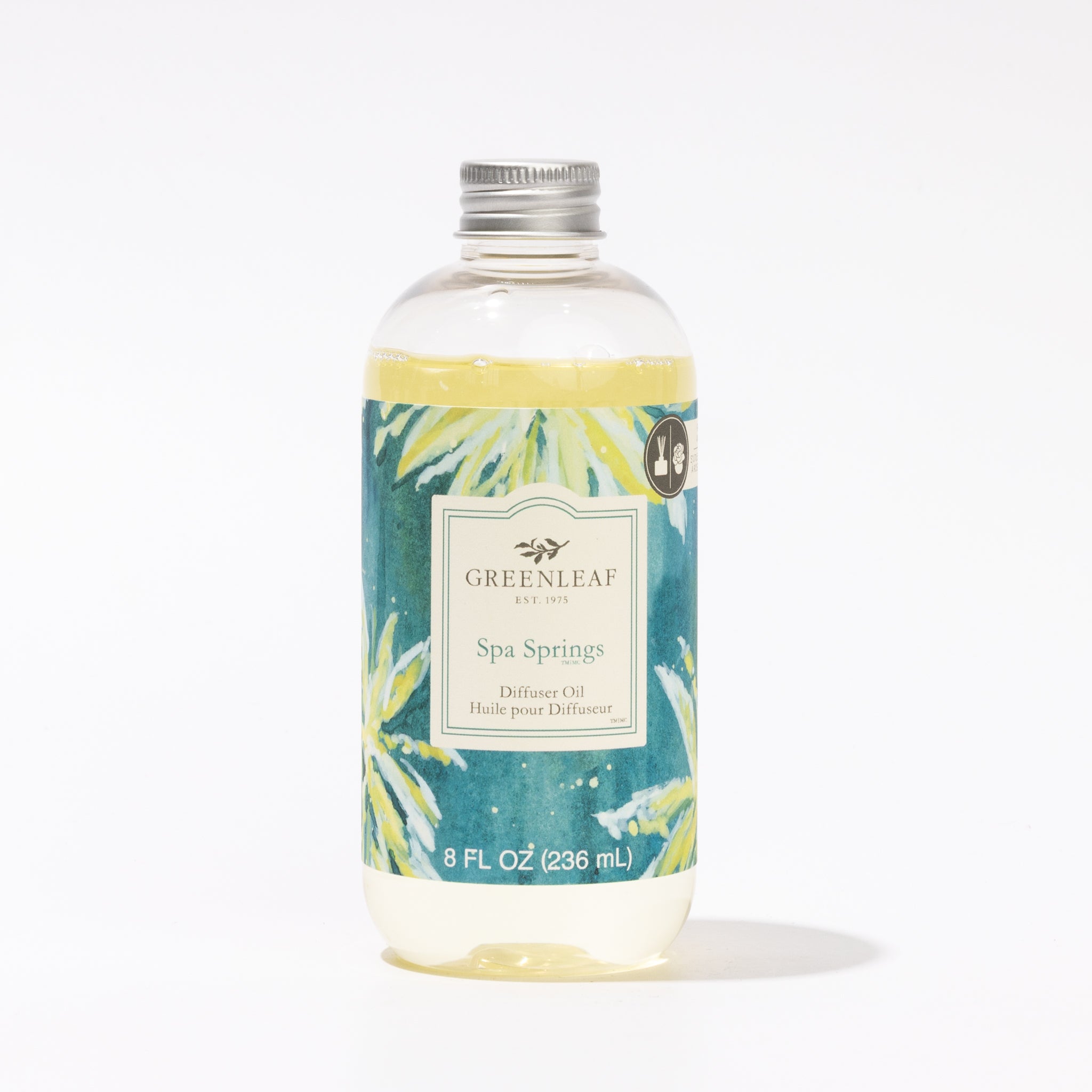 A clear plastic bottle of Greenleaf Gifts Spa Springs Diffuser Oil, 8 fl oz (236 mL), with a silver cap and a blue-green label with yellow and green leaves. Ideal as a Reed Diffuser refill for your favorite space.
