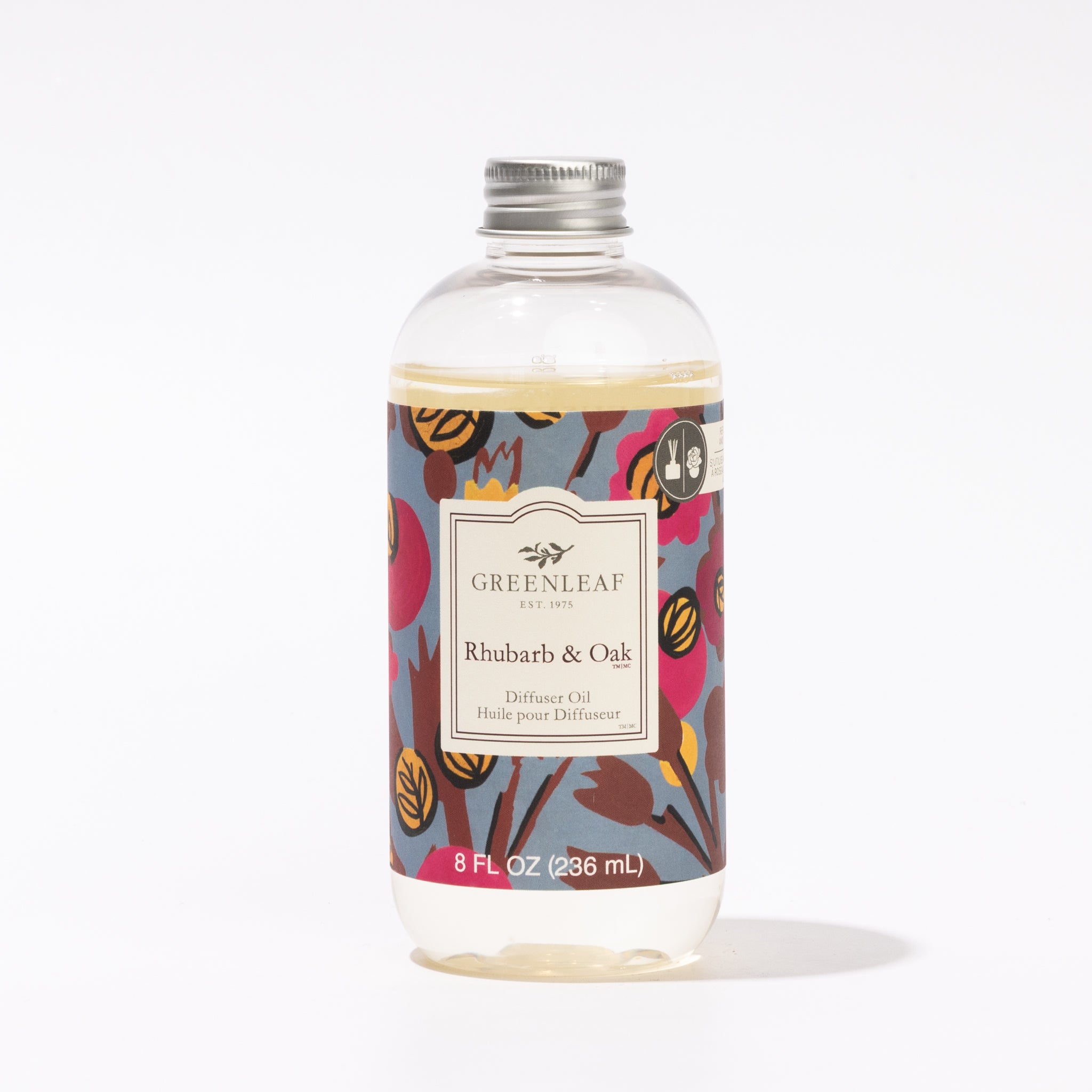 A clear bottle of Greenleaf Gifts Rhubarb & Oak Diffuser Oil with a silver cap features a floral label displaying the product name and 8 fl oz (236 ml) volume—ideal as a fragrance refill.