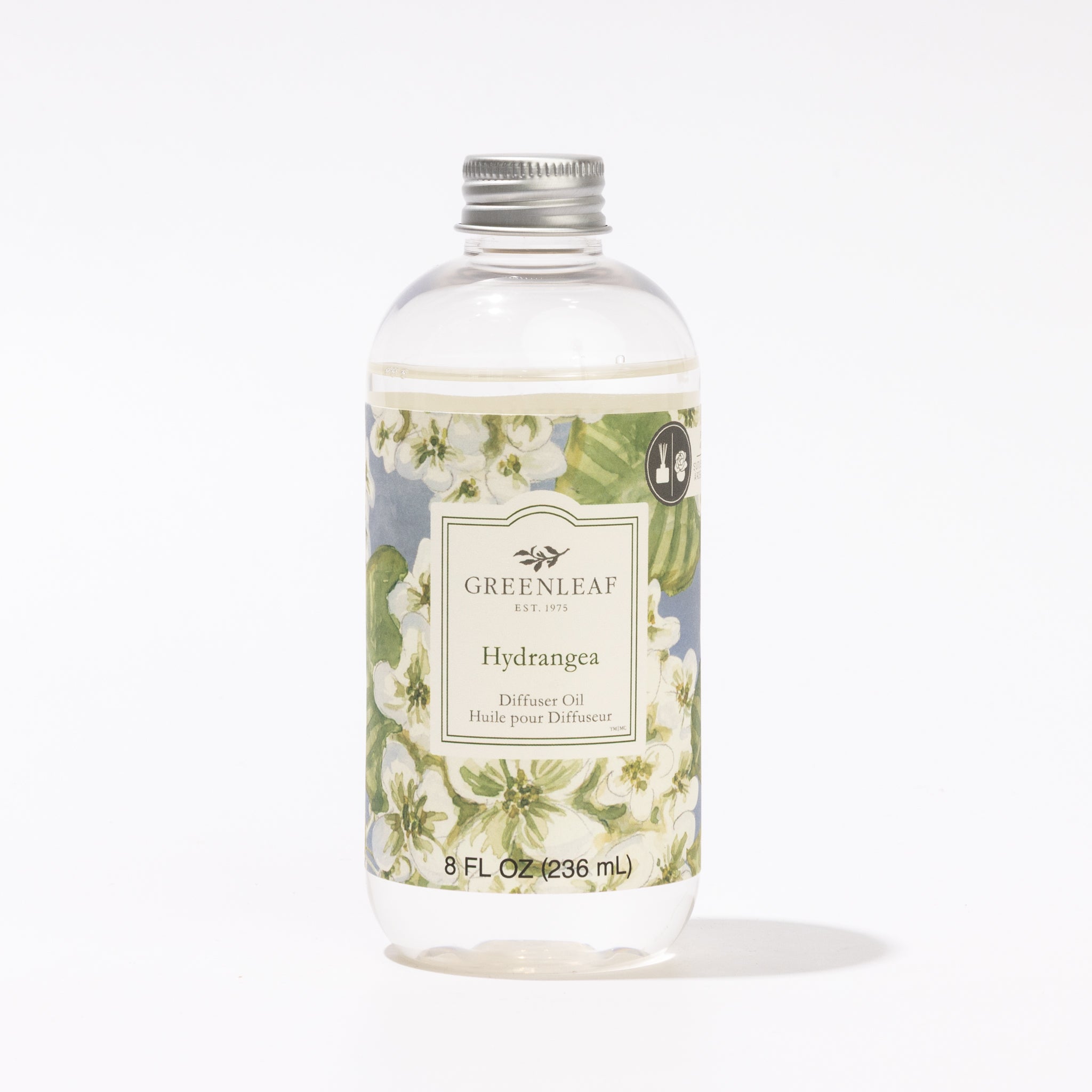 A clear plastic bottle labeled Hydrangea Diffuser Oil by Greenleaf Gifts features white hydrangeas on a blue background, a silver cap, and contains 8 fl oz (236 ml) of fragrance oil.