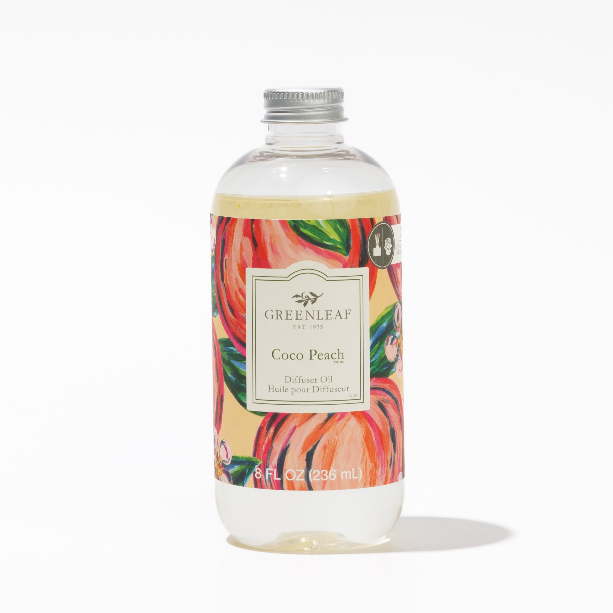 A clear bottle of Greenleaf Gifts Coco Peach Diffuser Oil with a silver cap. The label shows peach illustrations and states 8 fl oz (236 mL), ideal for pairing with your Greenleaf Flower Diffuser.