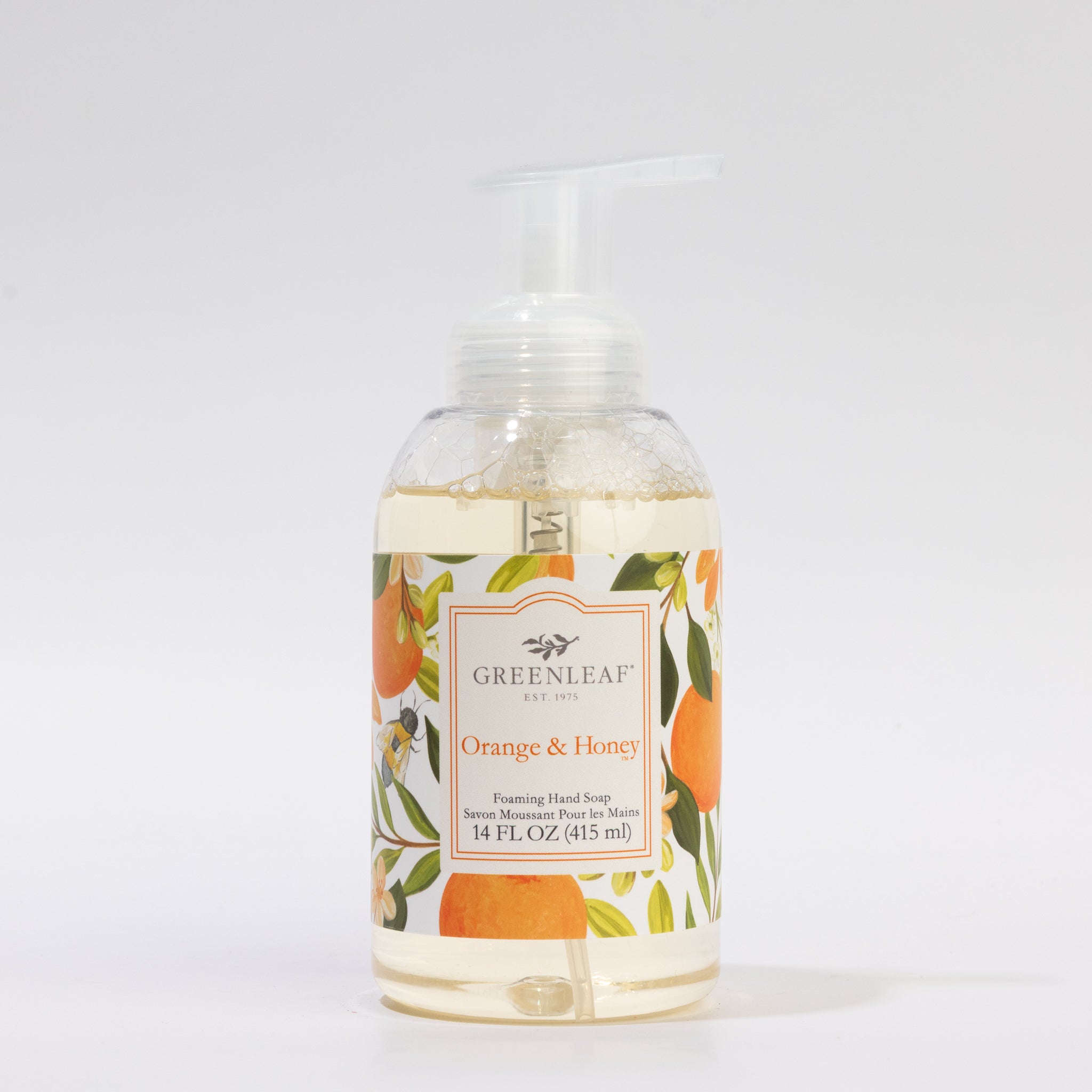 A clear pump bottle of Greenleaf Gifts Orange & Honey Foaming Hand Soap, 14 fl oz, with illustrated label—perfect beside your GLG321471S drinking glass on the counter.