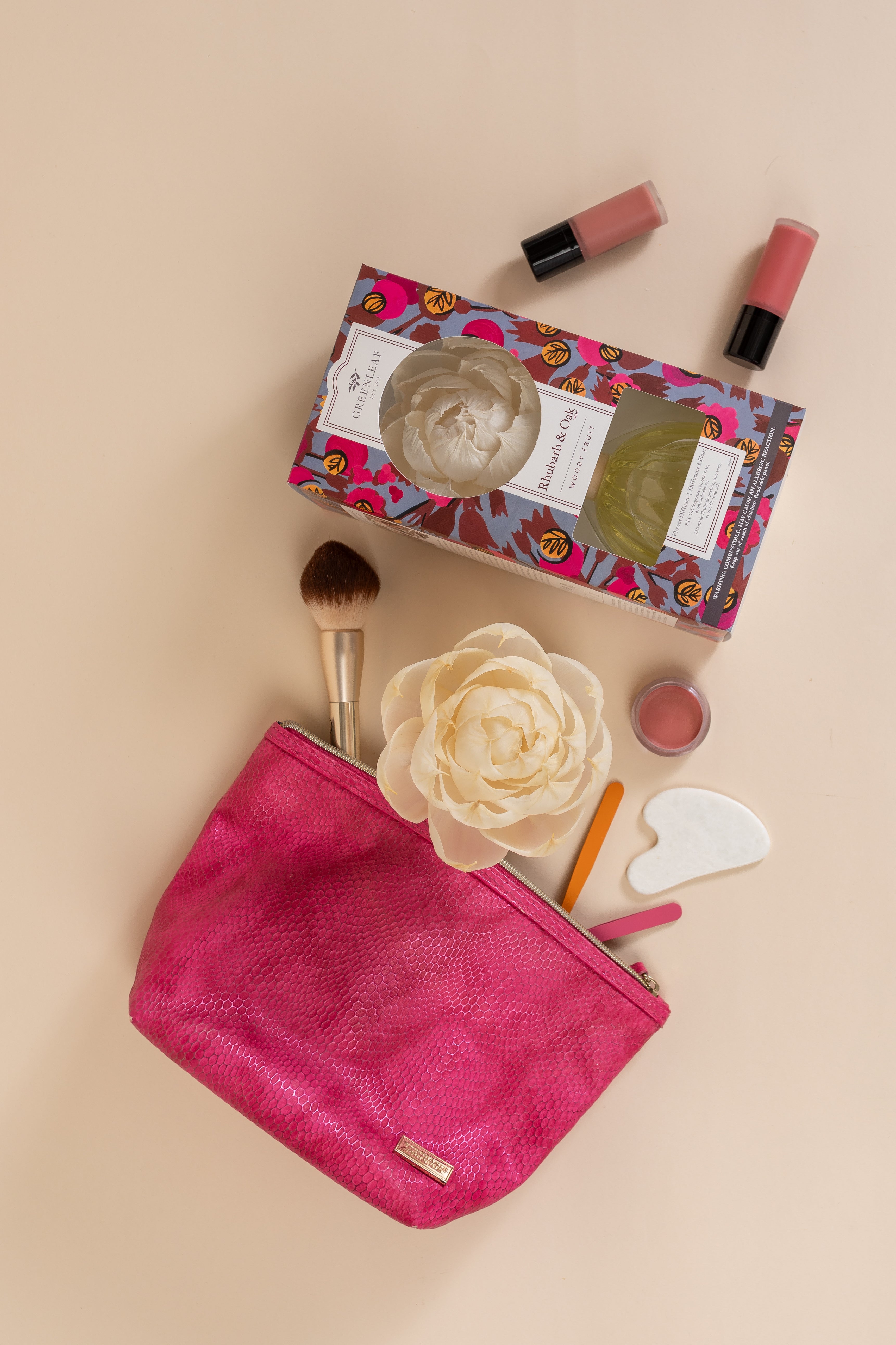 A flat lay featuring the Greenleaf Gifts Rhubarb & Oak Flower Diffuser on a beige background—perfect for adding a fresh touch to your space in 60 days.
