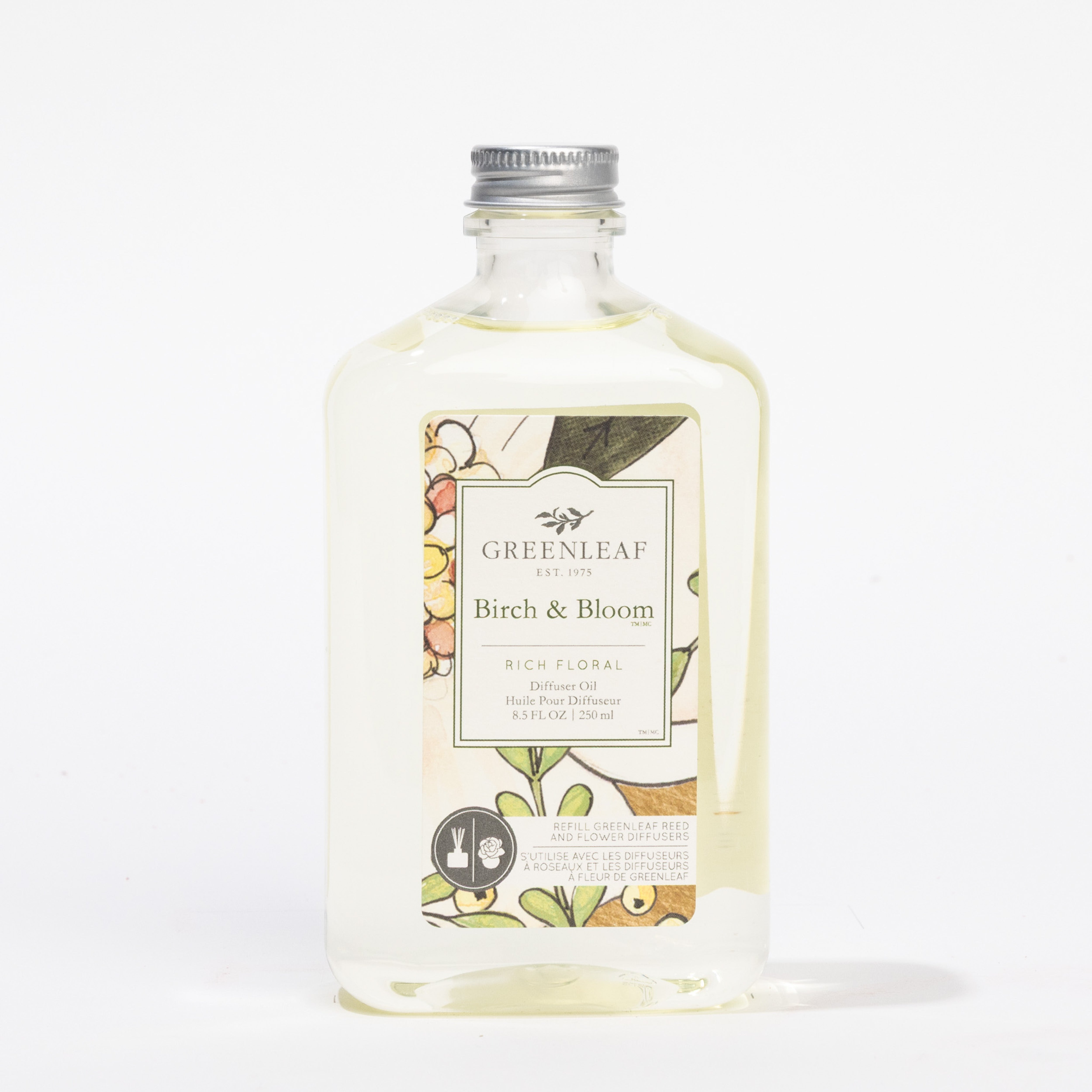 A clear bottle of Fast Bundle Birch & Bloom Flower Diffuser & Refill Oil with a silver cap and floral label is displayed against a white background, highlighting the elegant Fast Bundle fragrance.