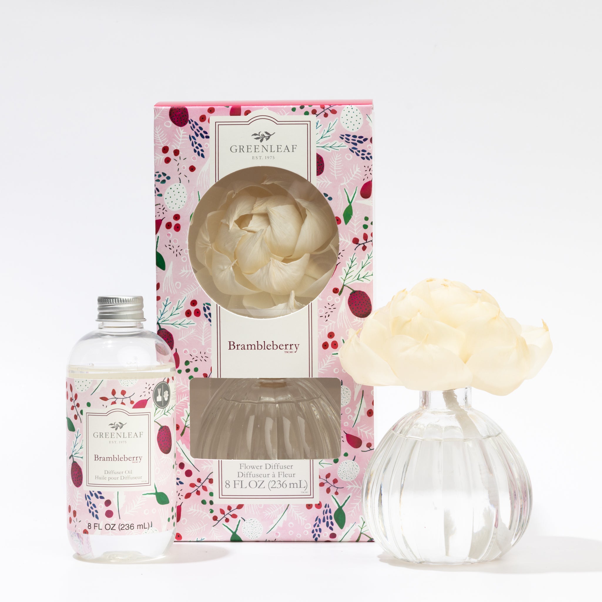 The Fast Bundle Brambleberry Flower Diffuser & Fragrance Refill Oil set features a floral-patterned box, a clear bottle of scented oil, and a vase with cream-colored artificial flower petals.