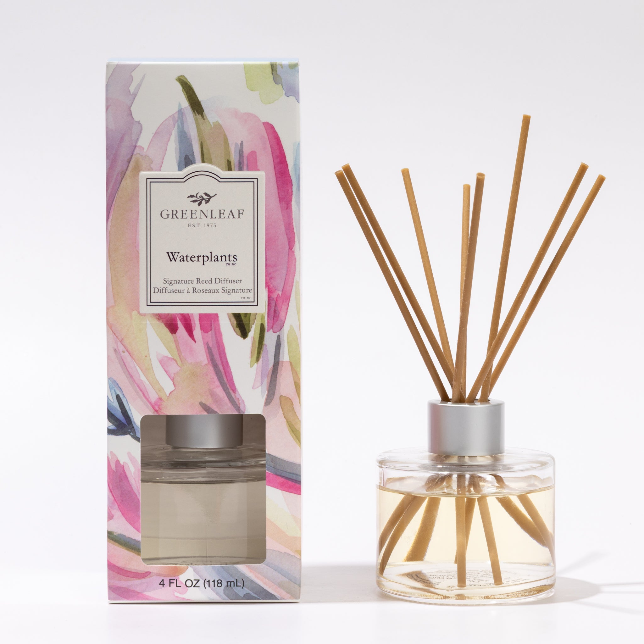 A bottle of Greenleaf Gifts Waterplants Diffuser Refill Oil, 4 FL OZ (118 mL), stands beside its floral box, filling the air with soothing hyacinth and ylang ylang notes.