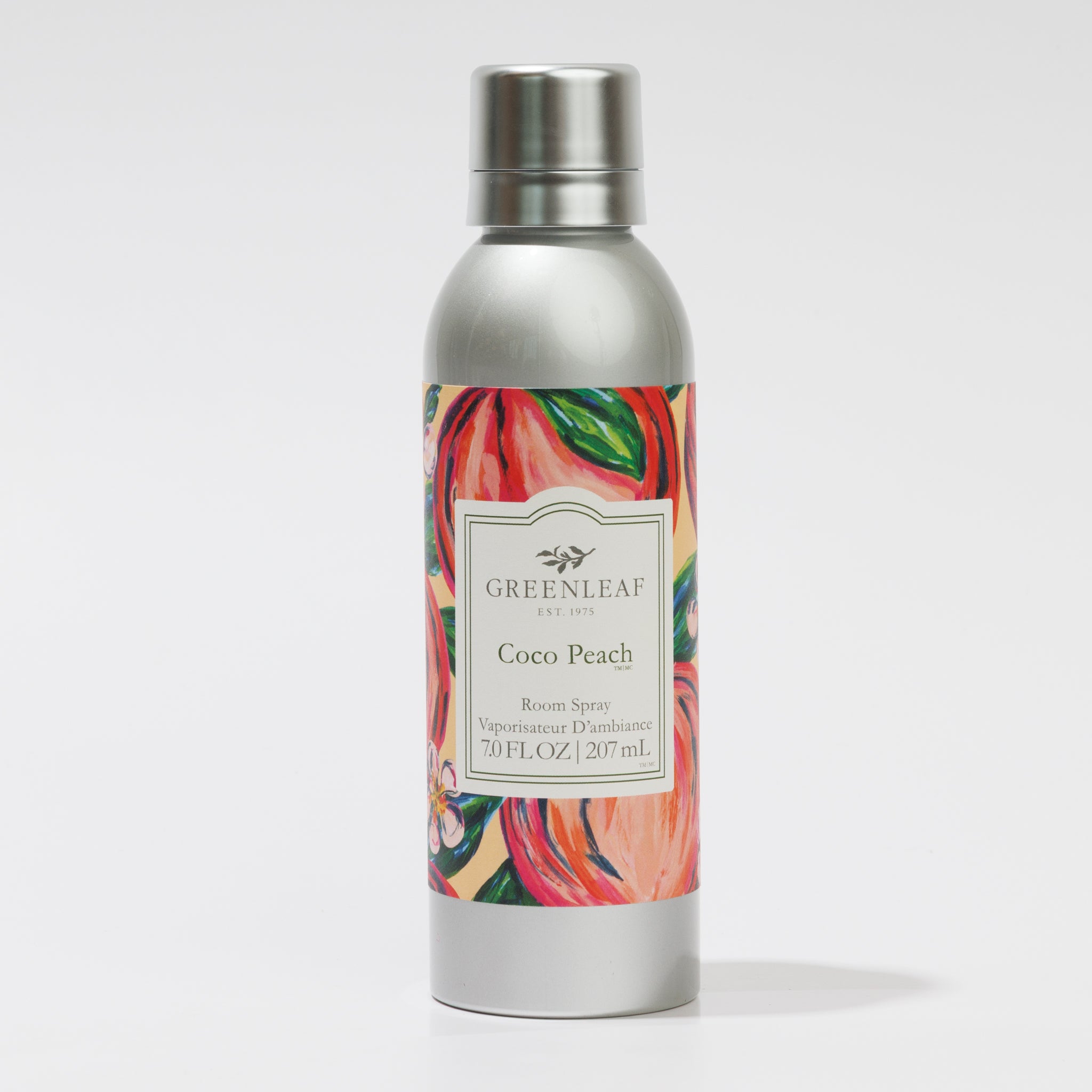 A 7oz (207ml) Greenleaf Gifts Coco Peach Room Spray bottle features a vibrant floral and peach design. The silver non-aerosol bottle, filled with refreshing fragrance, stands upright on a white background.